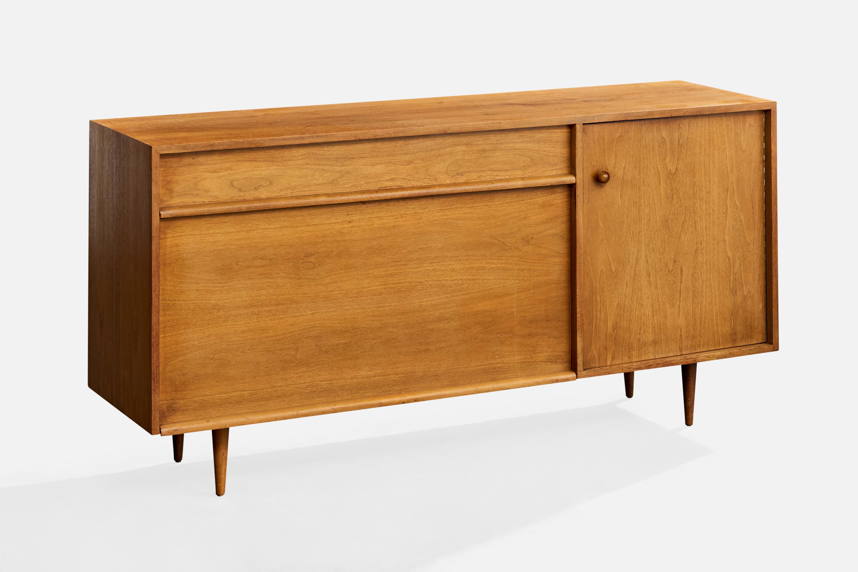 A walnut cabinet or sideboard designed by Milo Baughman and produced by Glenn of California, USA, c. 1950s.

Refinished.

Mild to moderate wear to exterior.

Mild to heavy wear inside.

Back panel is unfinished plywood with repair.

Inside right