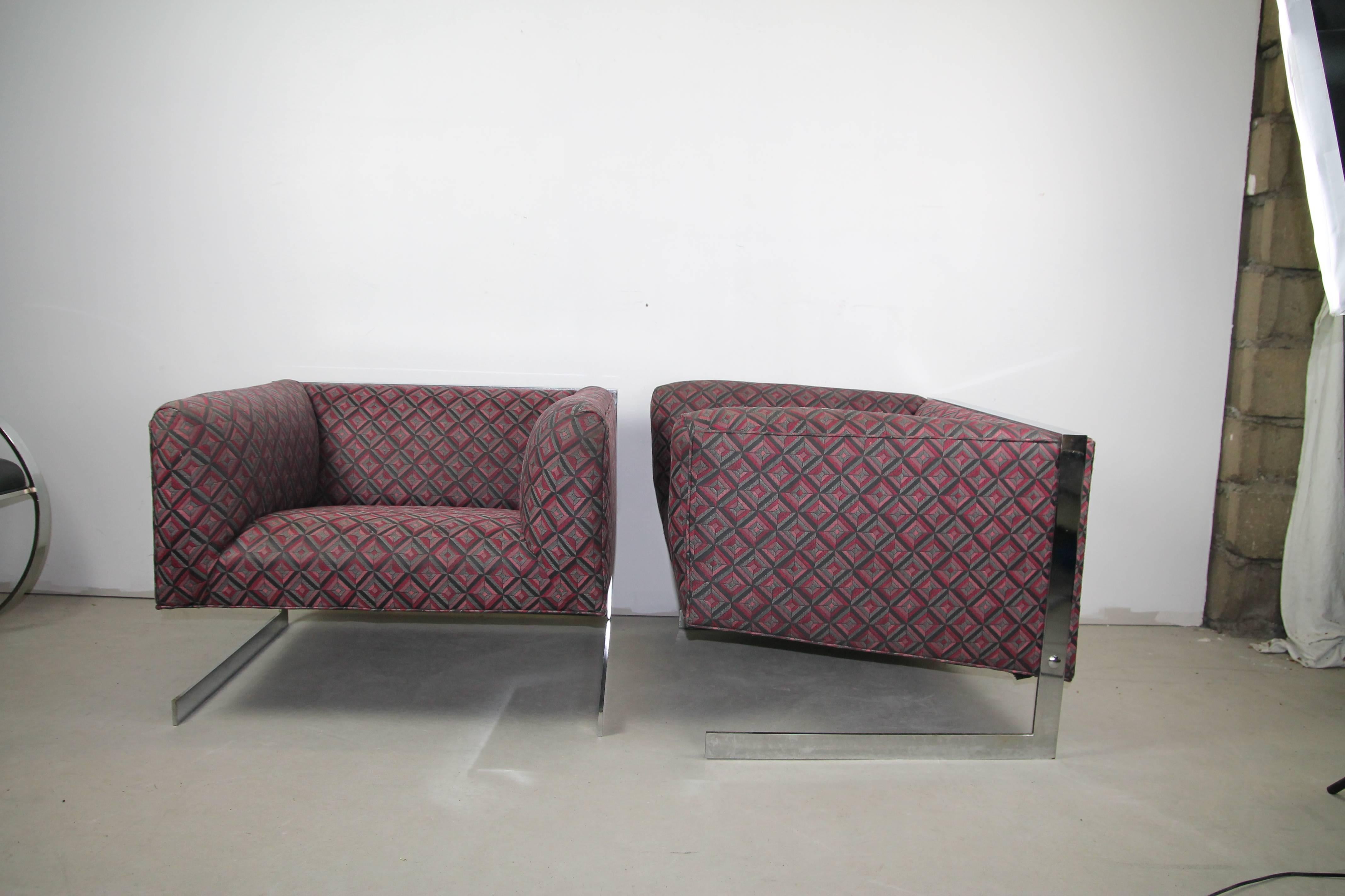 Pair of Cantilever lounge chairs. Retains the original fabric that can be used as is. Some darkening of the fabric in a few places and a couple slight pulls. Light scratches on the chrome and minor loss on the back legs but not very noticeable.