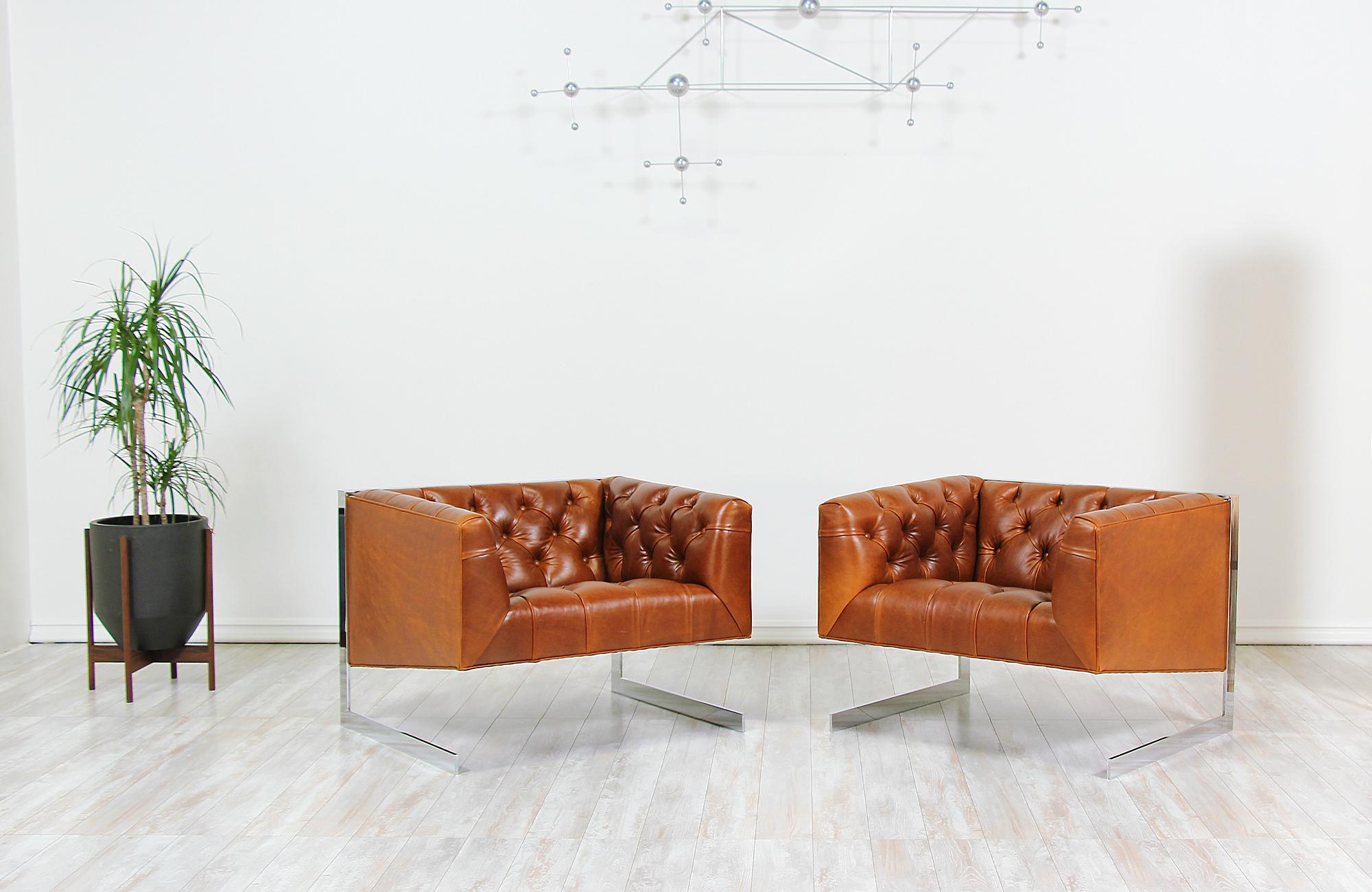 Pair of stylish lounge chairs designed by Milo Baughman for Thayer Coggin in the United States, circa 1960s. This pair of lounge chairs feature an L-shaped cantilevered steel base supporting the architectural cubed seat rest that has been newly