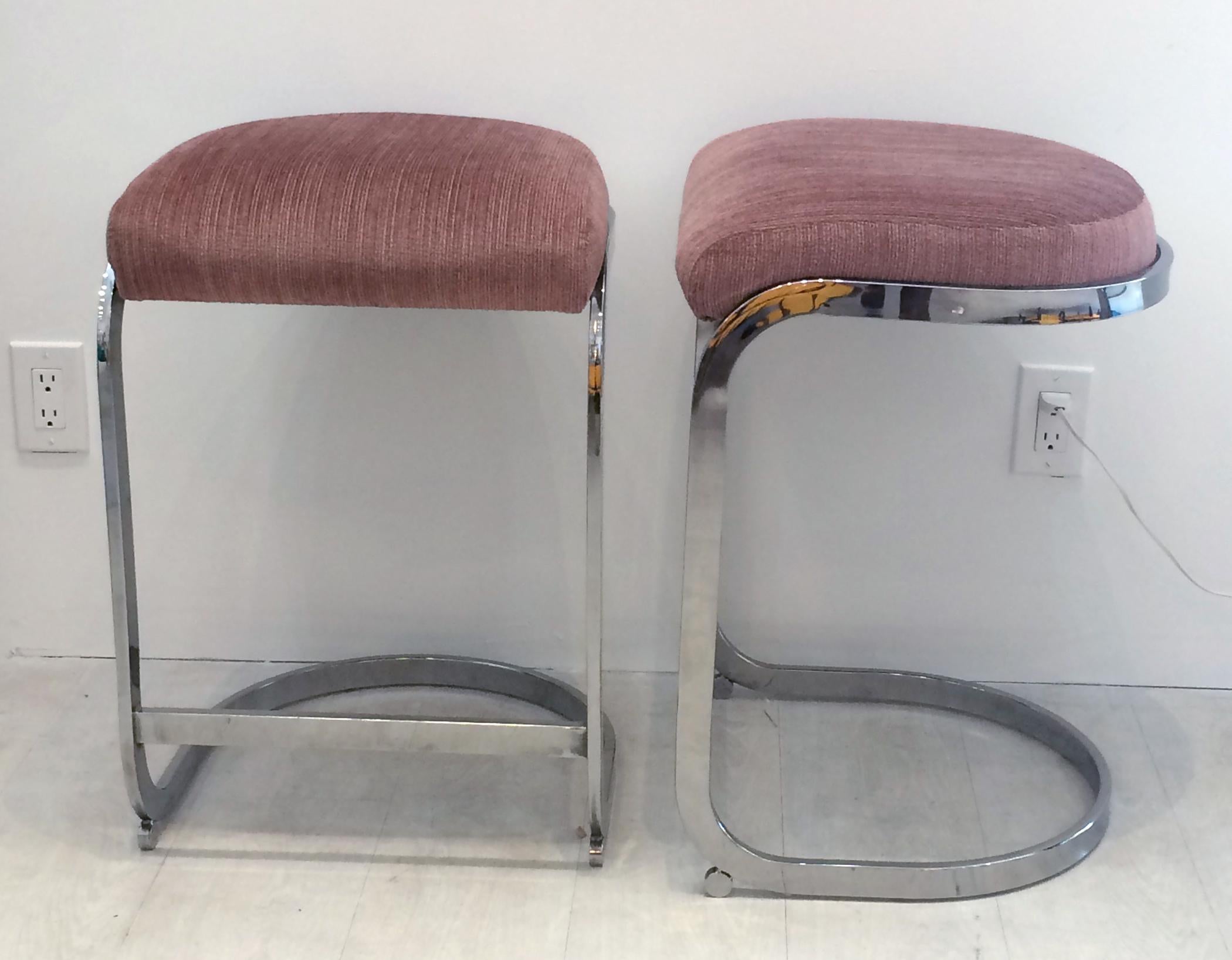 Set of four vintage cantilevered chrome bar stools with fabric seats. Designed by Milo Baughman. I've seen the manufacturer of these bar stools attributed to both DIA design institute of America and Dillingham. The set is in very good condition both