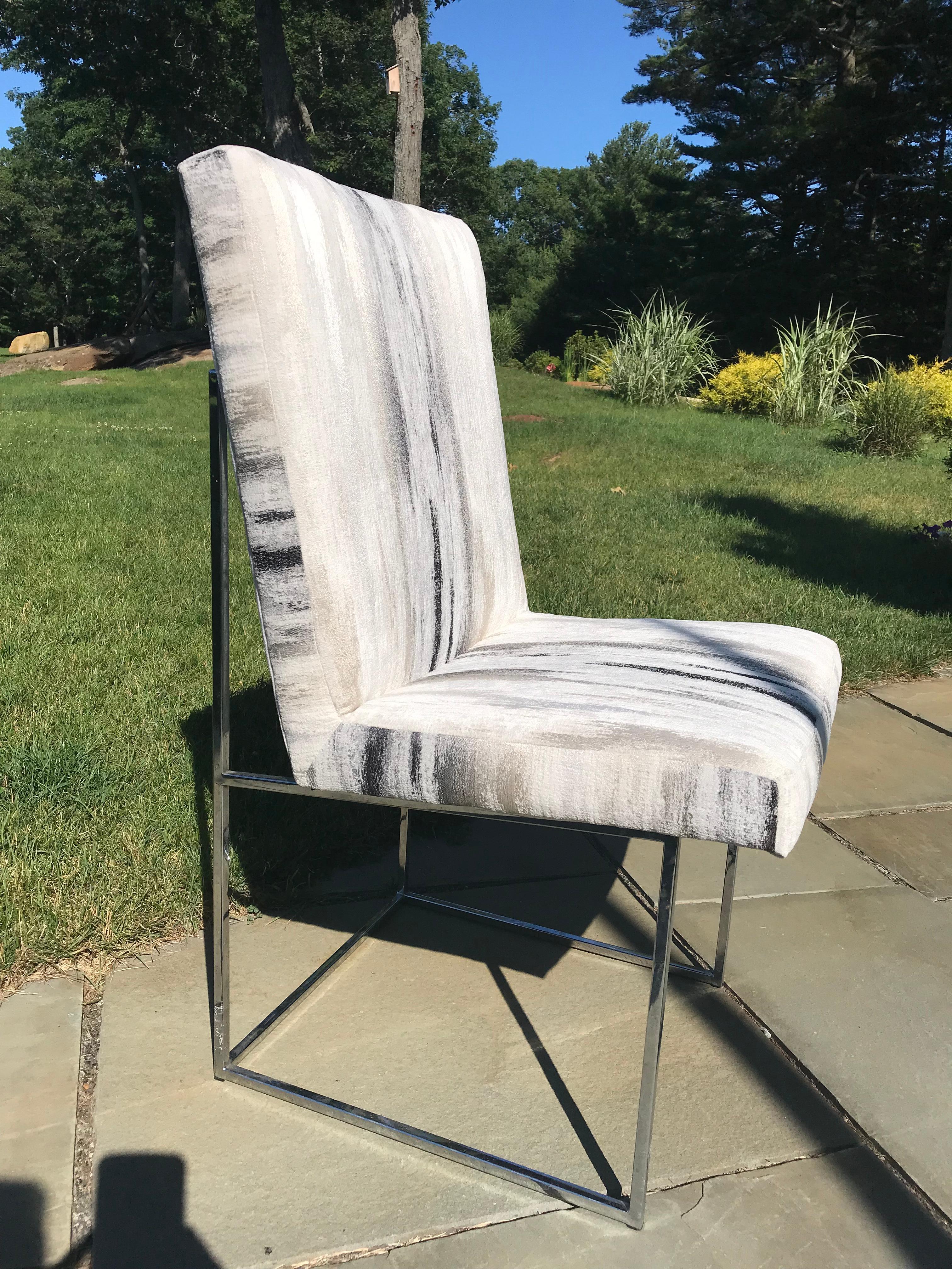 A most elegant and comfortable set of 6 Milo Baughman dining chairs, two armchairs and four side chairs. 
One is reupholstered in a high quality contemporary fabric as a suggestion. We purchased enough fabric to reupholster the remaining chairs.
The