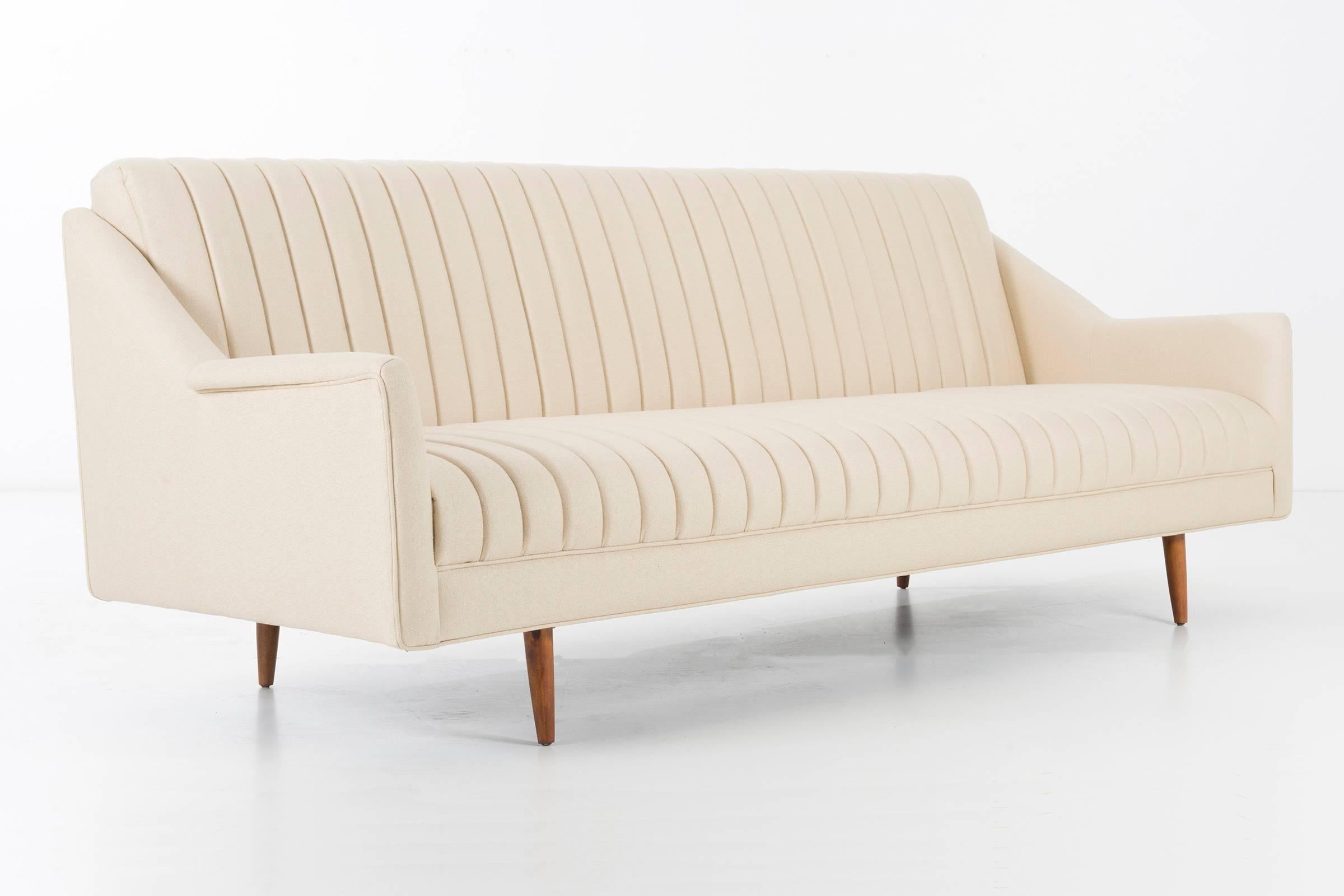 Milo Baughman channel back sofa, circa 1954.
reupholstered with Great Plains wool/poly blend 
Solid turned wood legs.
Shown Coffee Table Sam Maloof sold separately 