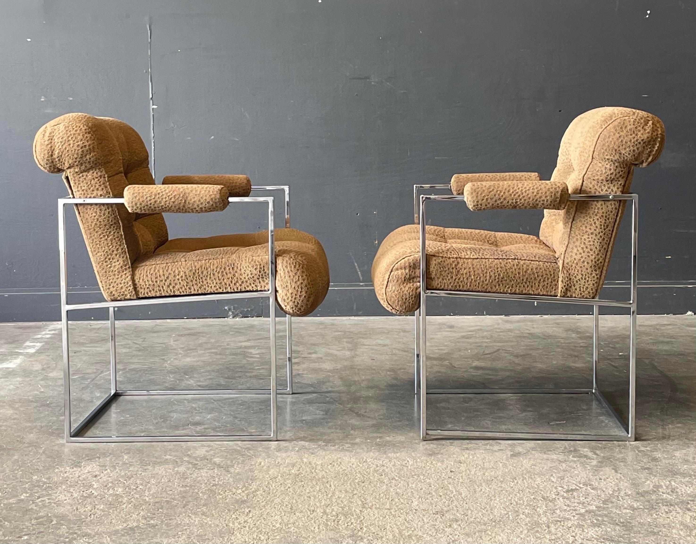 This modern pair of Milo Baughman chrome and fabric side chairs feature a thinline architectural frame. Upholstered with a cheetah inspired textured fabric in tan. The seat and back cushion are finished with box tufting. Timeless design!