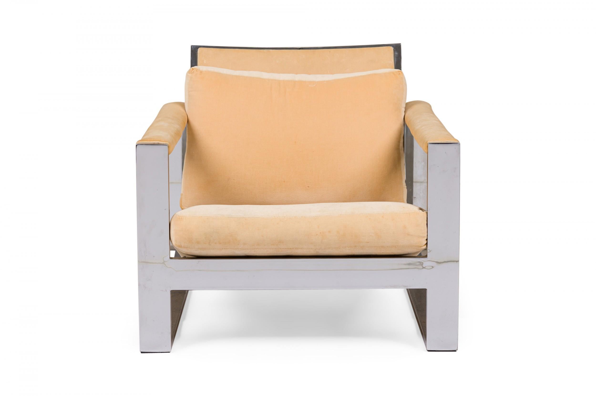 American Mid-Century 'Tank' form lounge / armchair with a flat bar polished chrome frame and peach colored fabric upholstered seat, back and arm covers. (MILO BAUGHMAN).
 