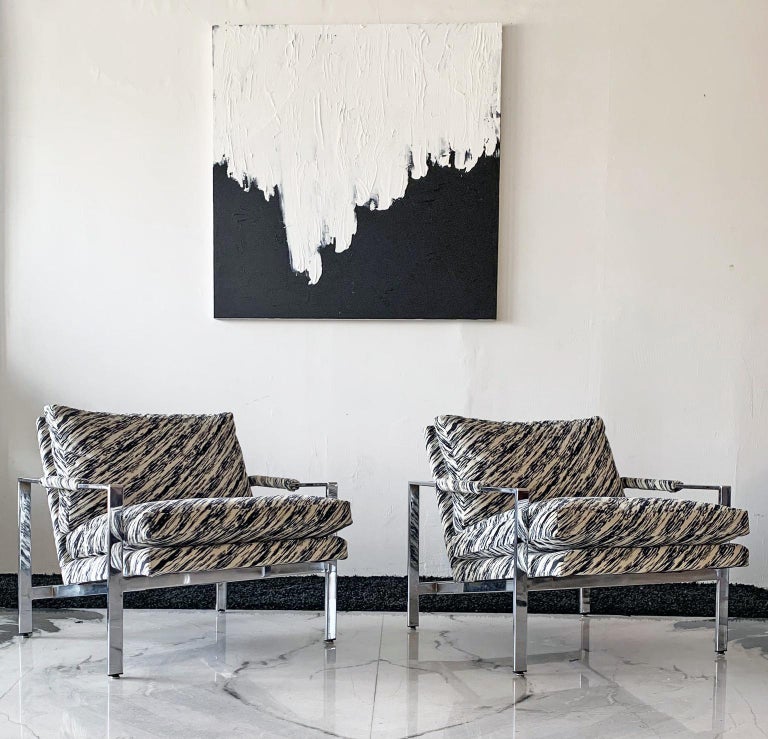 This pair of Milo Baughman lounge chairs is simply put: stunning! This pair of Milo Baughman lounge chairs, C. 1960, were reupholstered in the early 1990's in a velvet 90's style black and white print fabrice, that has a slight zebra feel, but much