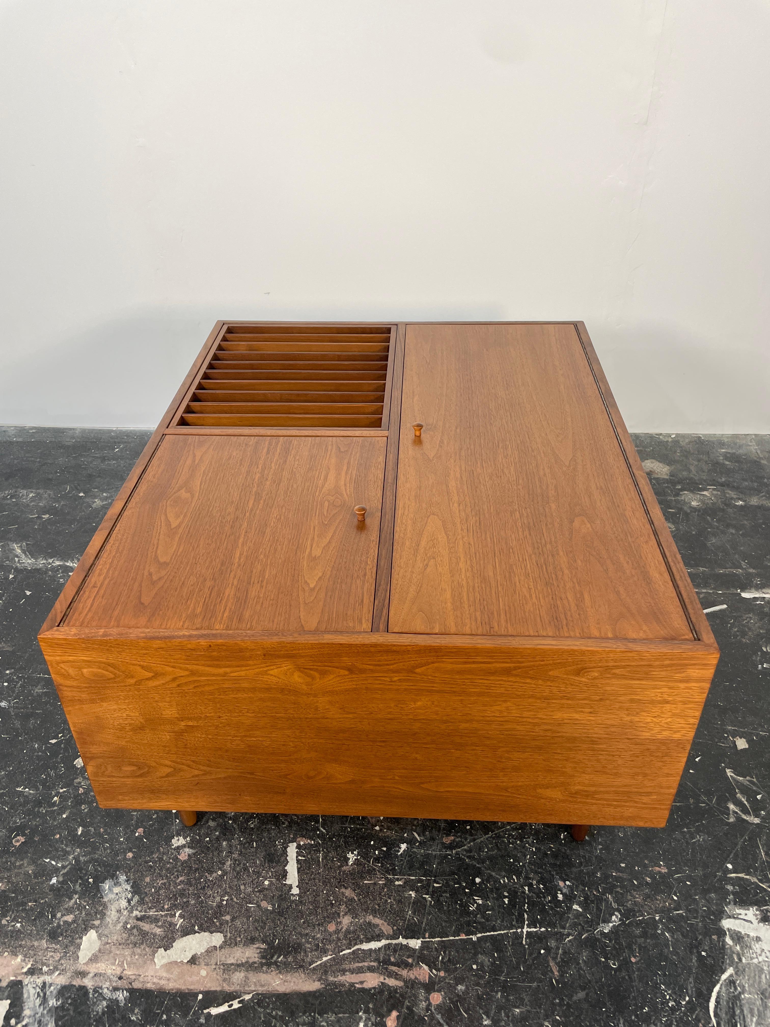 Rare large walnut coffee table by Milo Baughman for Glenn of California c.1950s, USA. This unique table features ample storage with two deep hinged cabinet doors. The cabinets open to reveal one large storage cabinet and a divided storage cabinet. A