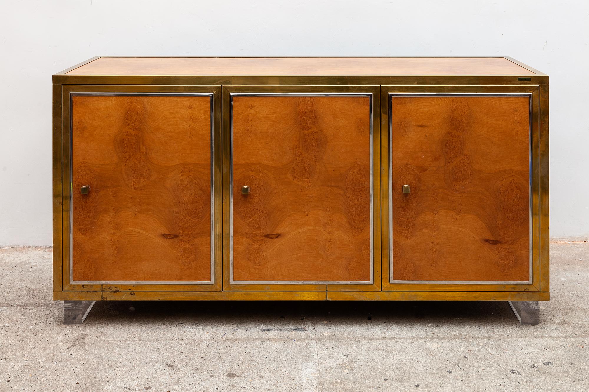 Milo Baughman Style credenza sideboard. Burl maple and brass finish. Excellent condition, Vintage sideboard/credenza in a stylish light burl maple brass finish and clear Lucite legs. Three doors with gold and silver trim. Dimensions: 151 W x 77.5 H