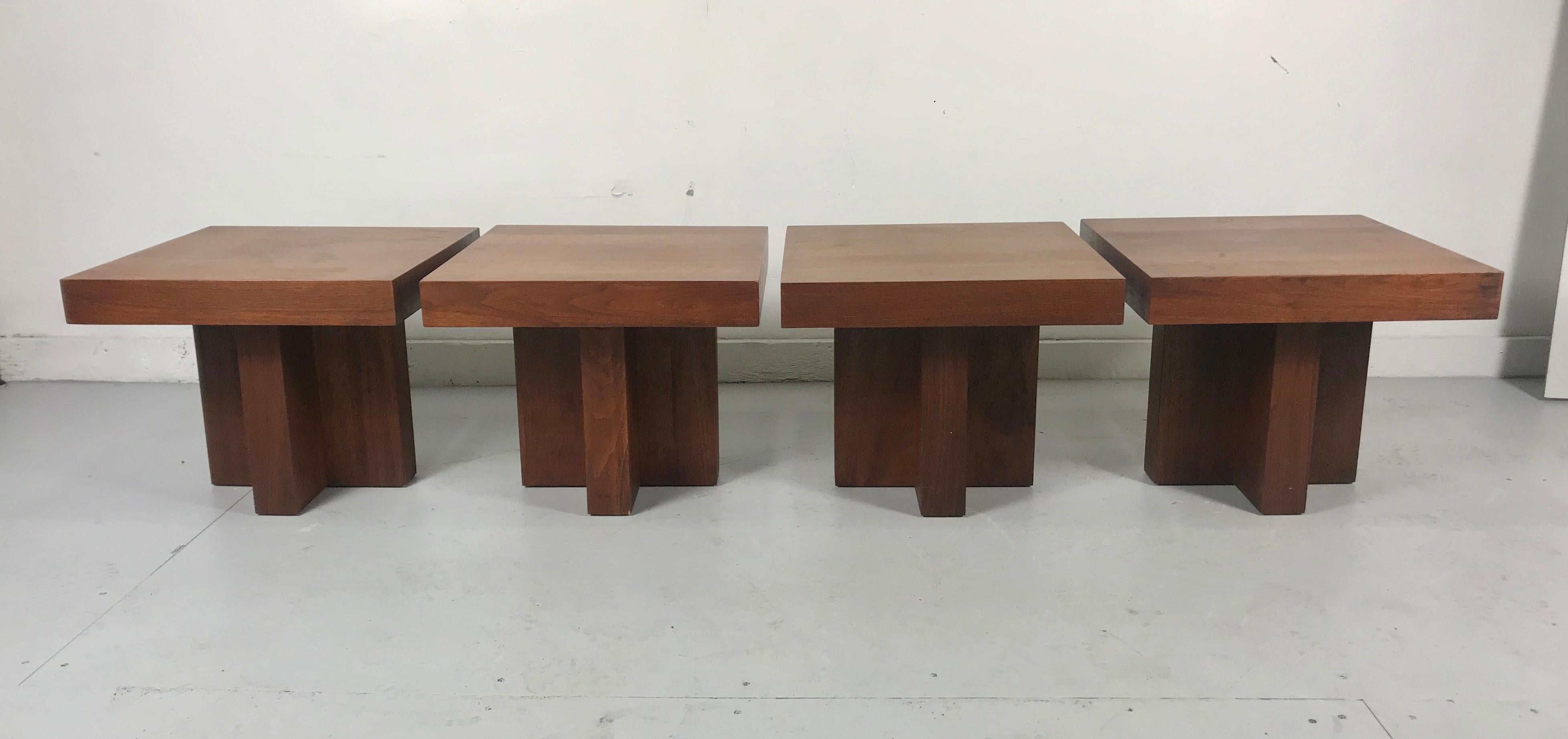 Stunning set of 4 walnut end tables, American, circa 1960s. These tables have a clean lined architectural design. Frank Lloyd Wright inspired. Versatile design, can be used as end or side tables, nightstands, or pushed together to be used as a