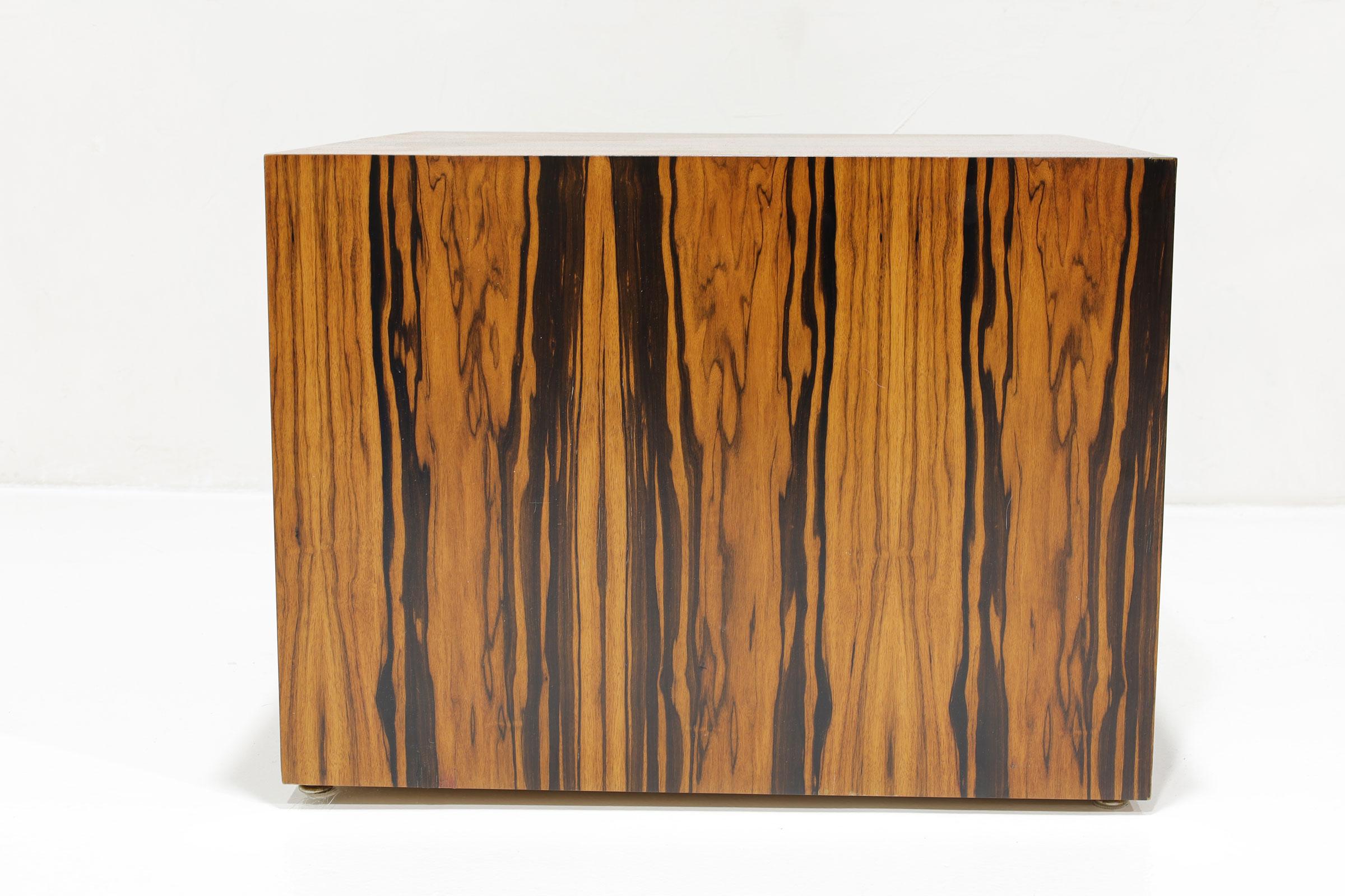 Enhance your living space with the Milo Baughman Cube Side or End Table in Rosewood. This exquisite piece boasts a beautiful and simple design to highlight the dramatic graining of this rosewood, ensuring it stands out in any room. As a