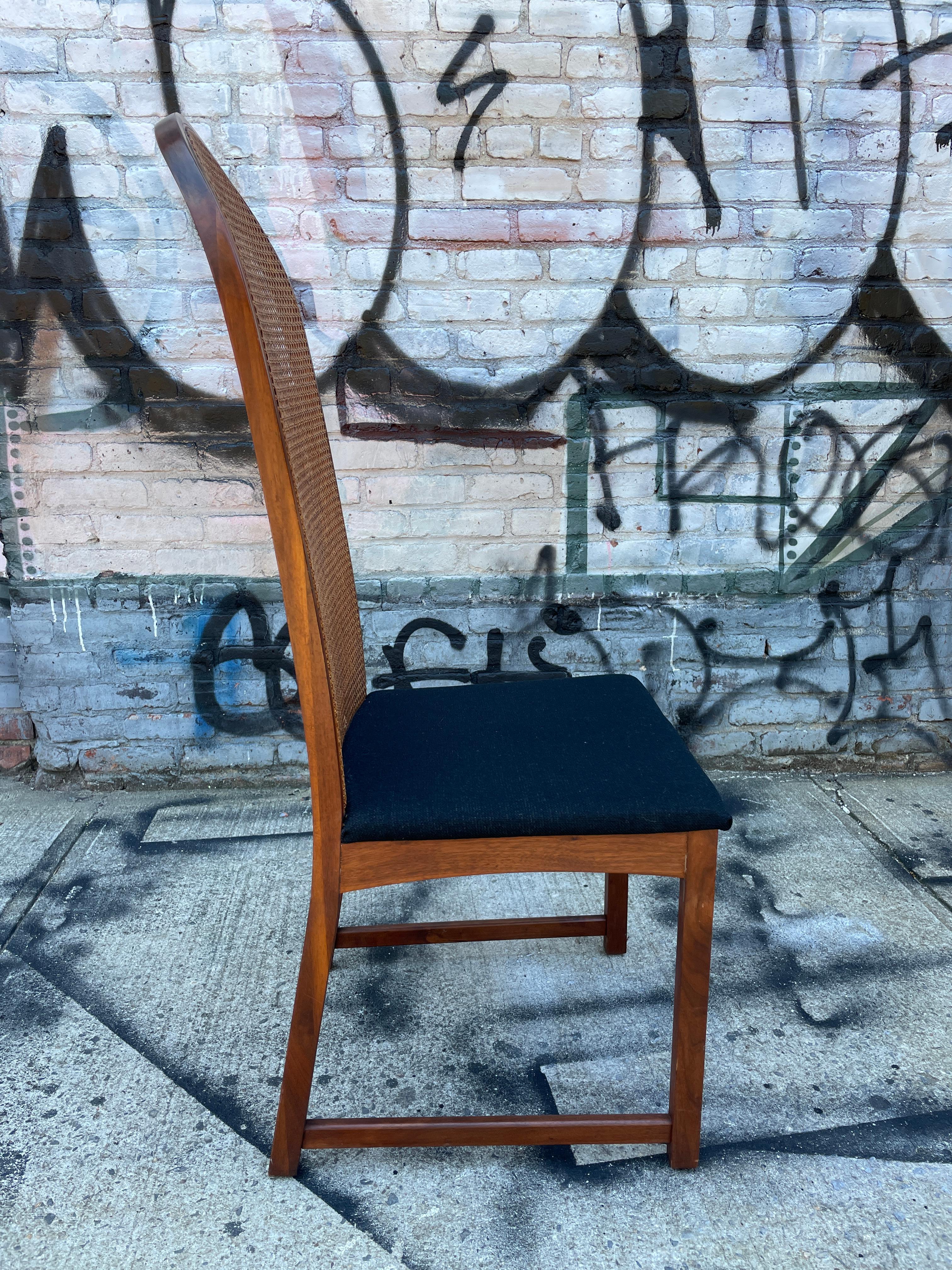 BeautifulMilo Baughman high curved back cane dining chairs. Chairs have no arms and have all the same black upholstery. Beautiful simple design very comfortable. Very easy to reupholster in your choose of fabric. Cane is in great vintage condition.