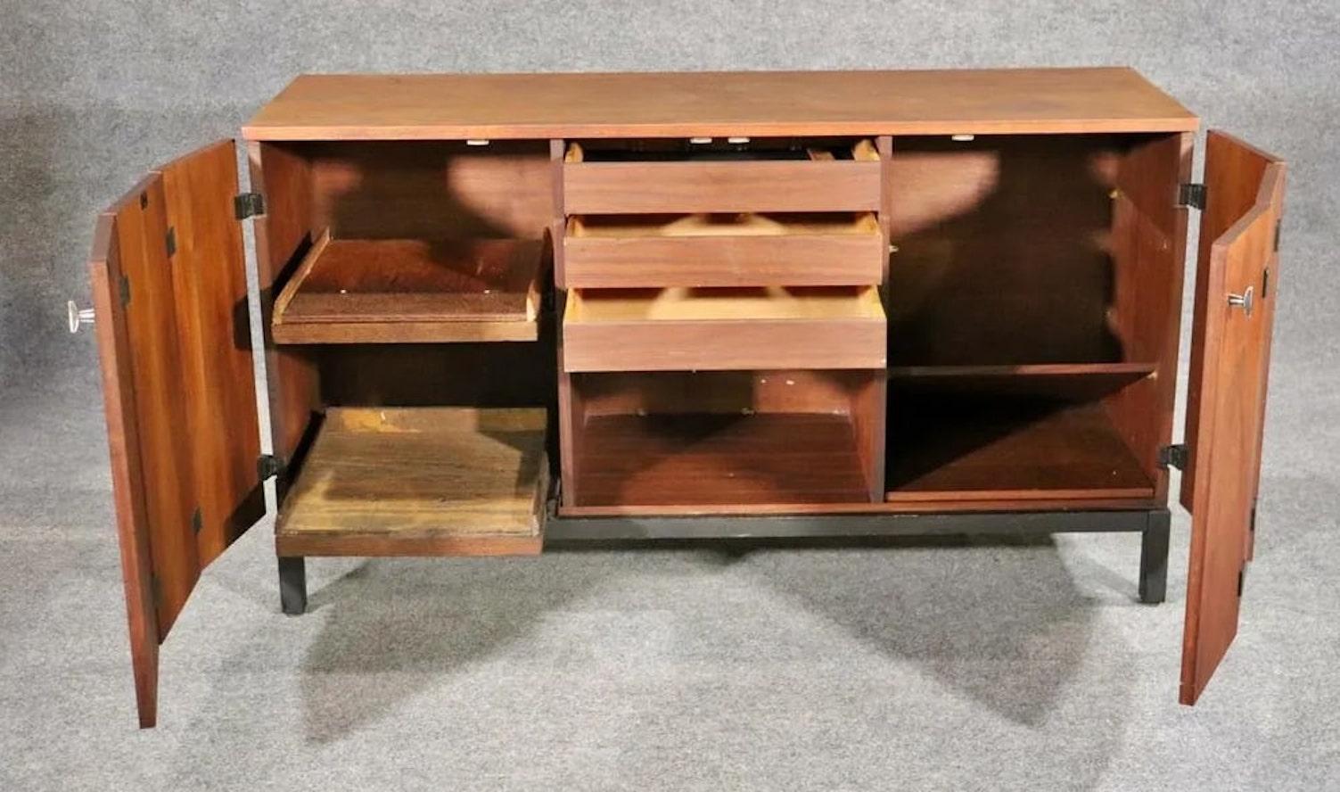 Mid-century modern sideboard with bi-fold doors, matte black base, and matching black exposed hinges. Designed for Directional by Milo Baughman, and manufactured by Johnson Furniture in Grand Rapids.
Please confirm location NY or NJ.