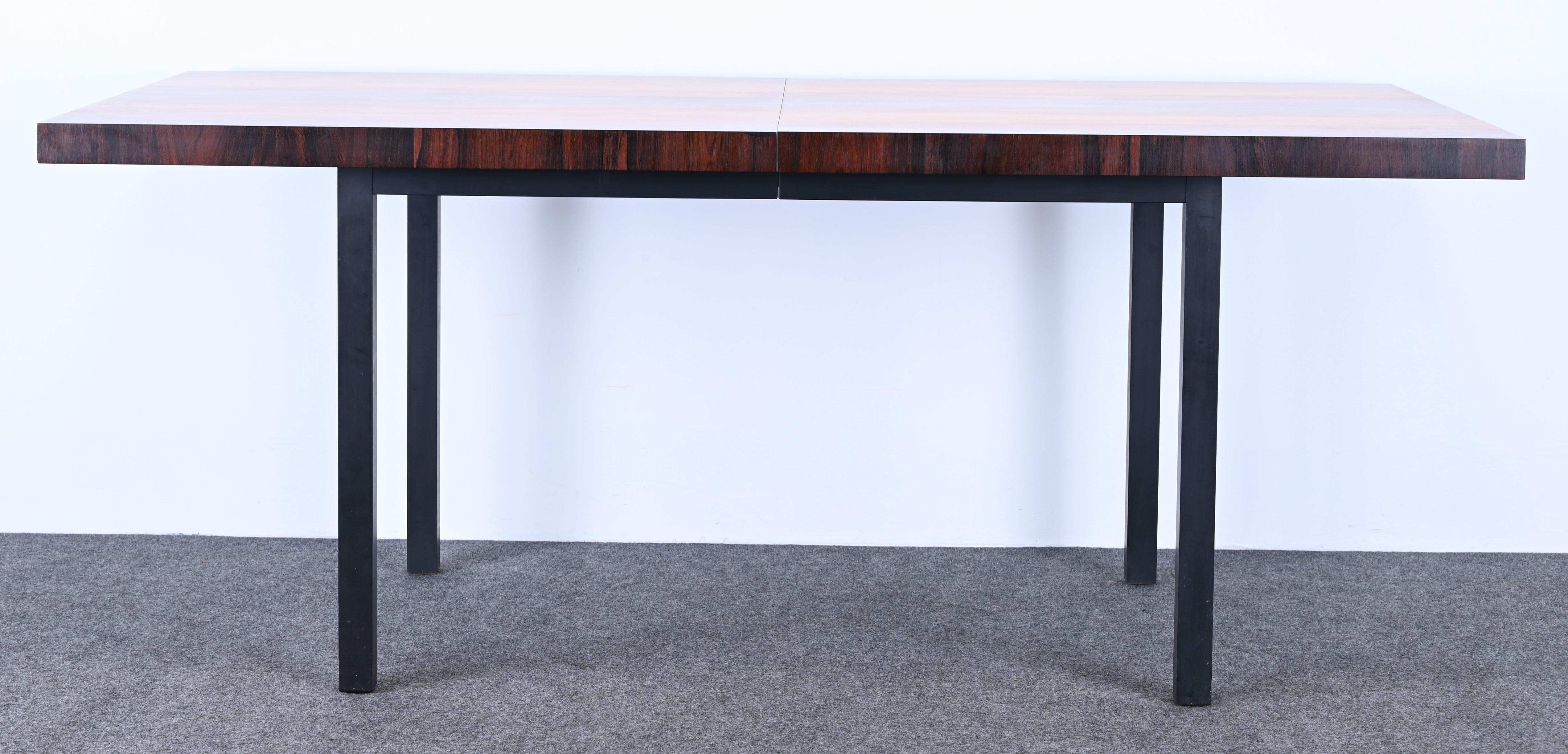 A beautiful Mid-Century Modern dining table designed by Milo Baughman for Directional. The table is made of gorgeous teak, rosewood, and walnut, has two leaves, and opens up to 112 inches long. Perfect for family gatherings and holidays. Some minor