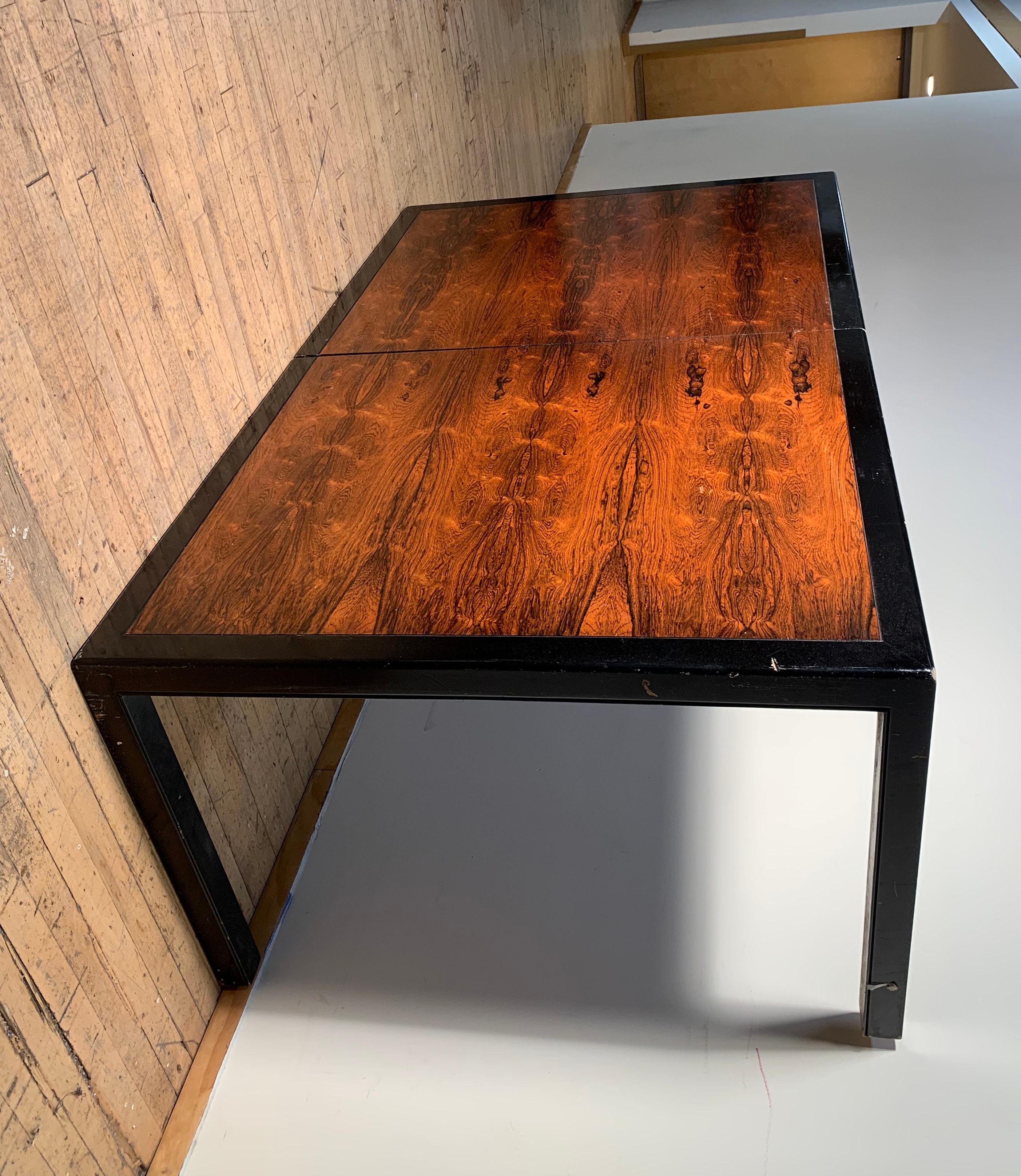 A beautiful Vintage Milo Baughman Rosewood dining table for Directional. Comes with 3 leafs not photographed. Will add photos of these shortly. Modern Parsons leg form with a clean black apron picture frame of Rosewood. High end