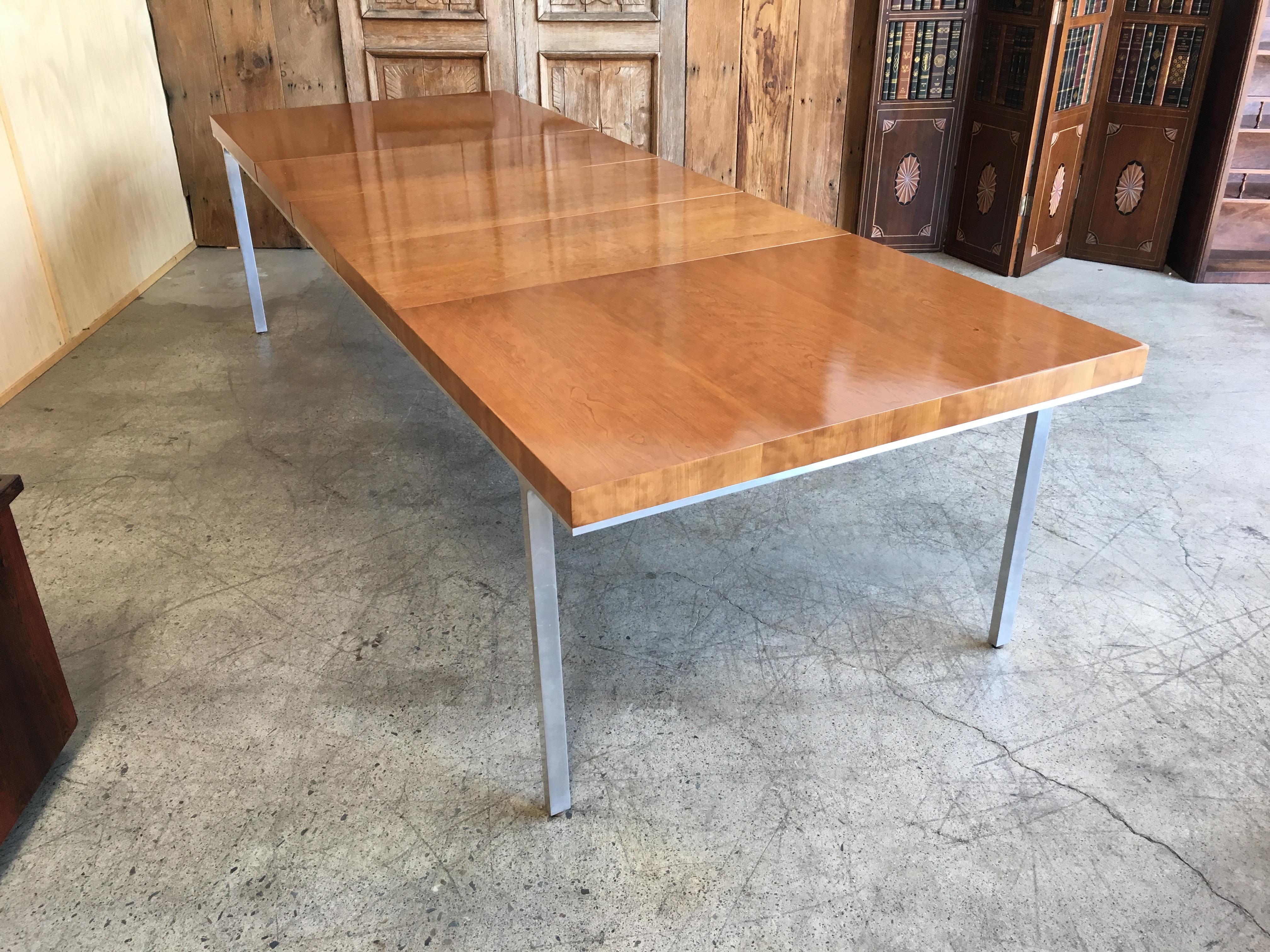 Very versatile table with the combination of wood and aluminum legs and apron 
This massive table was refinished not to long ago in a light walnut finish 
 There are three leaves, each one measures 18 inches. Length without the Leaves is 63.5.