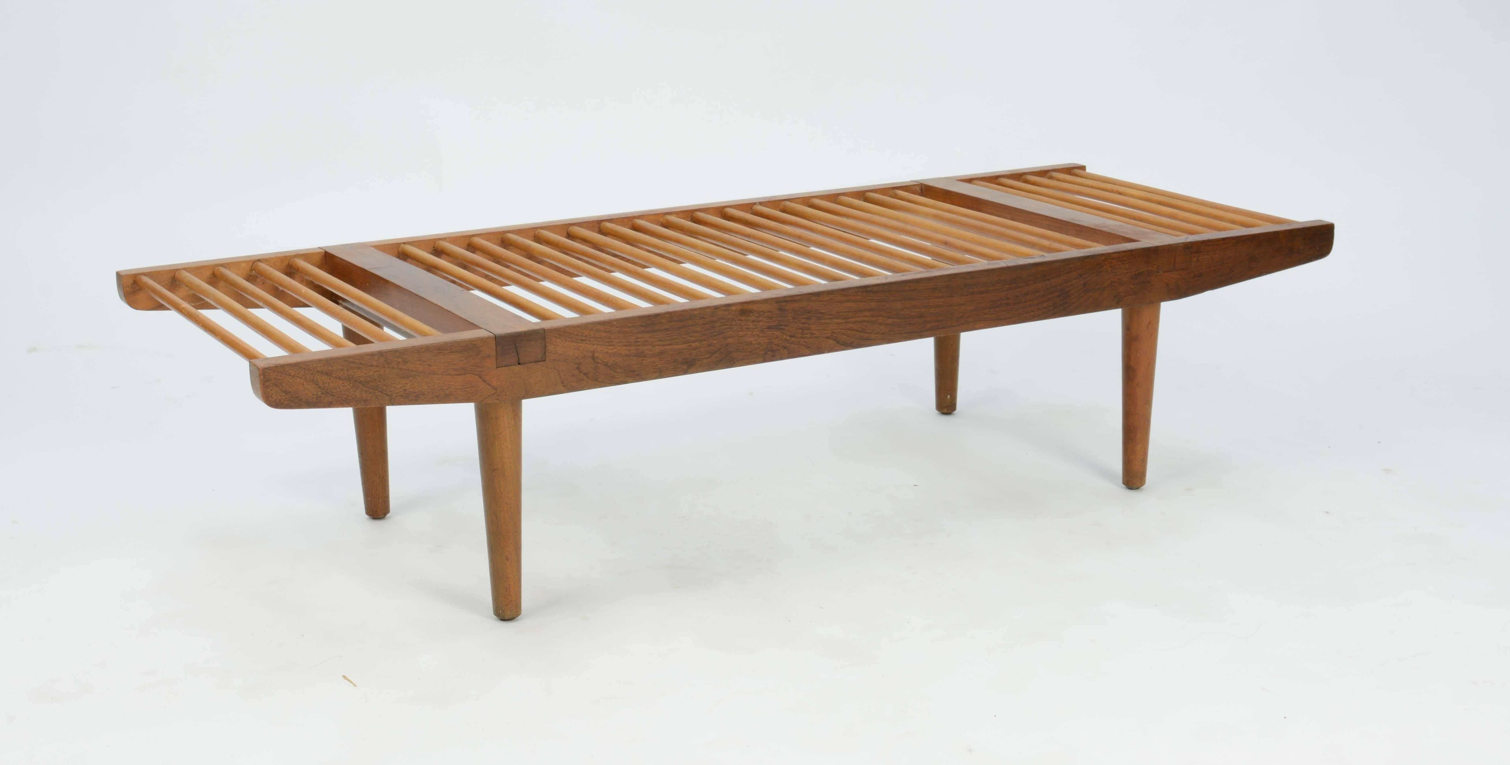 Milo Baughman's for Glenn of California large dowel bench, circa late 1950s. This lovely piece of early California modern that uses walnut and maple for contrasting colors.