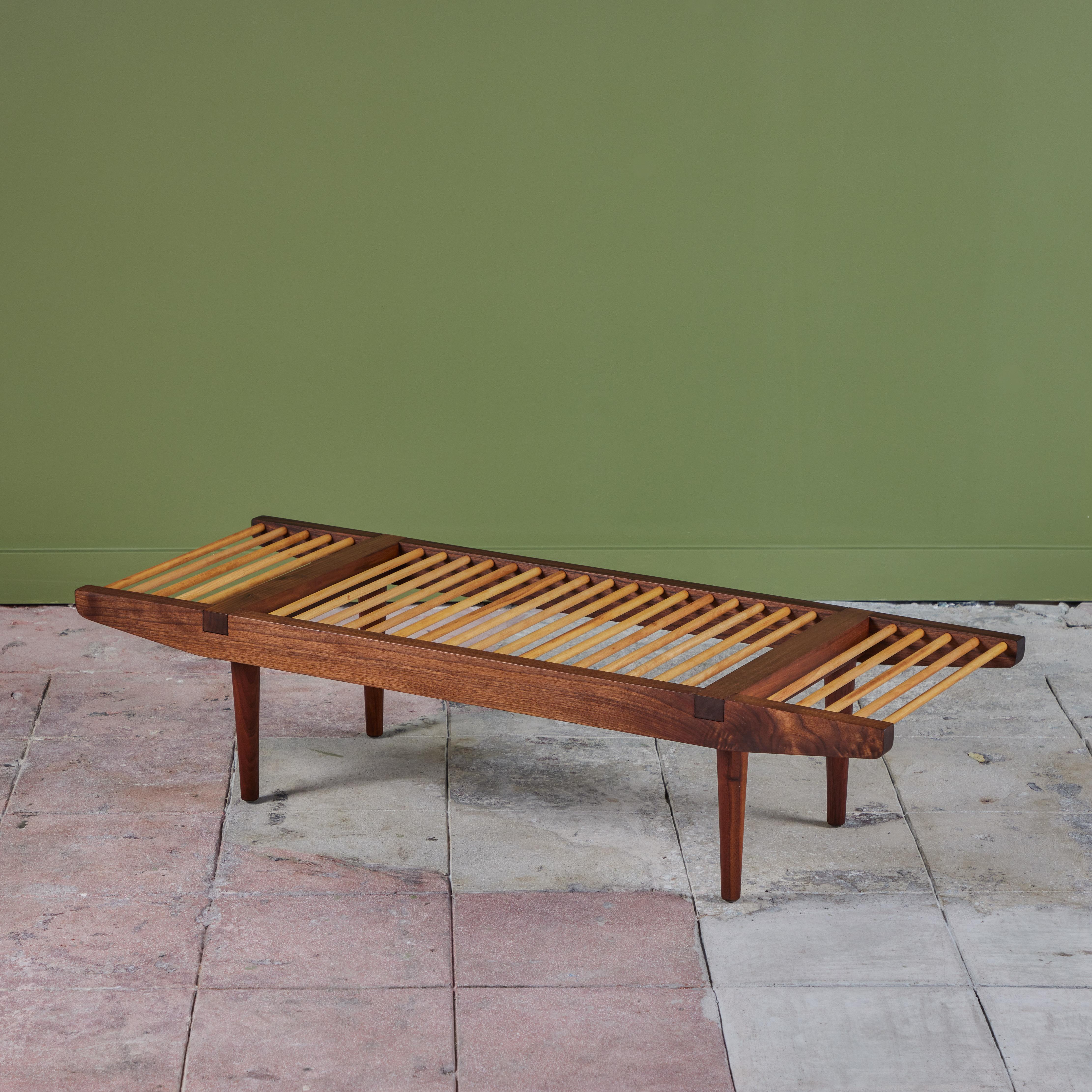 A multifunctional piece designed in the 1950s by Milo Baughman for Glenn of California. Most commonly seen as a bench, the piece has a walnut frame that tapers towards each end with walnut spacers and delicate rounded legs. The seat is created from
