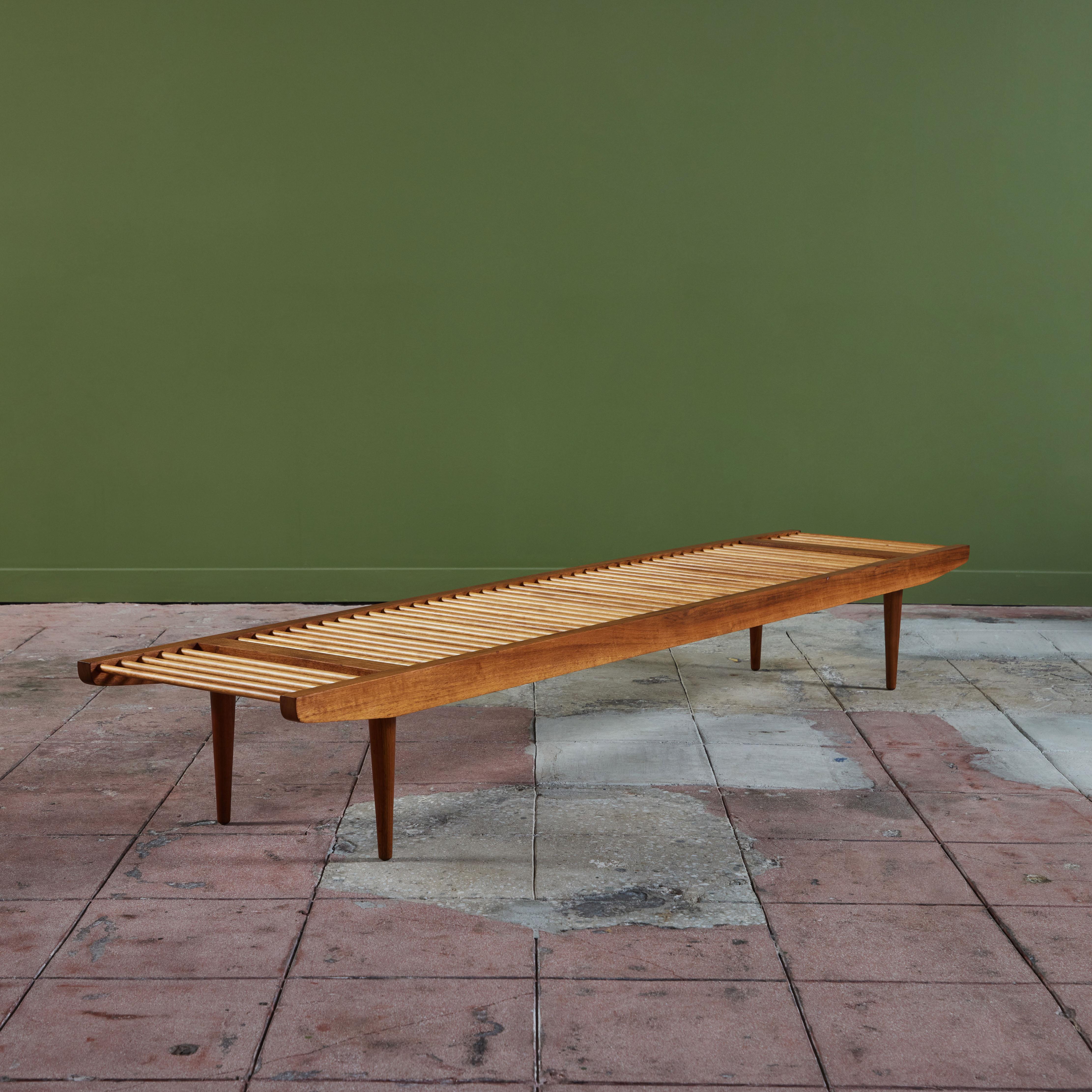 A multifunctional piece designed in the 1950s by Milo Baughman for Glenn of California. Most commonly seen as a bench, the piece has a walnut frame that tapers towards each end with walnut spacers and delicate rounded legs. The seat is created from