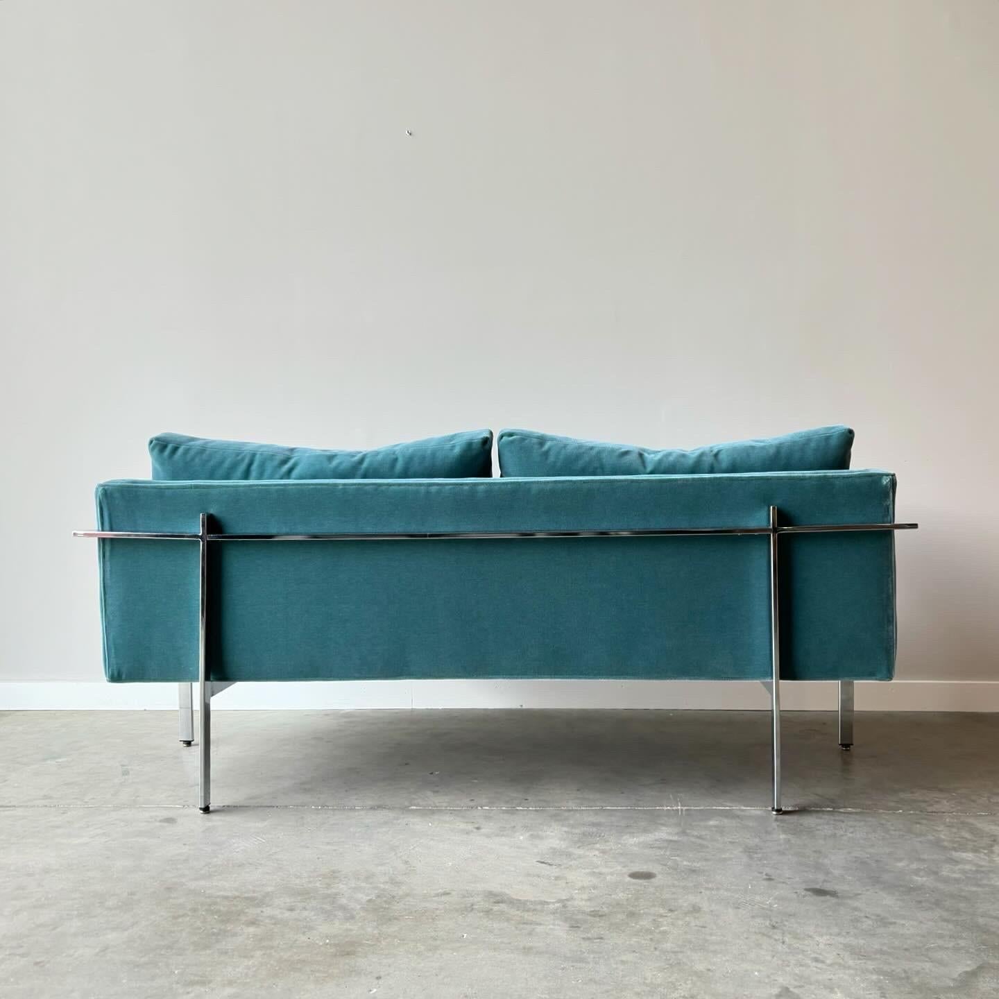 Designed by Milo Baughman in 1968, the Drop In sofa is a timeless, classic modern sofa, with striking good looks from every angle. 
Polished chrome bar running around the sofa and down the legs. Newly upholstered in teal mohair fabric with new foam