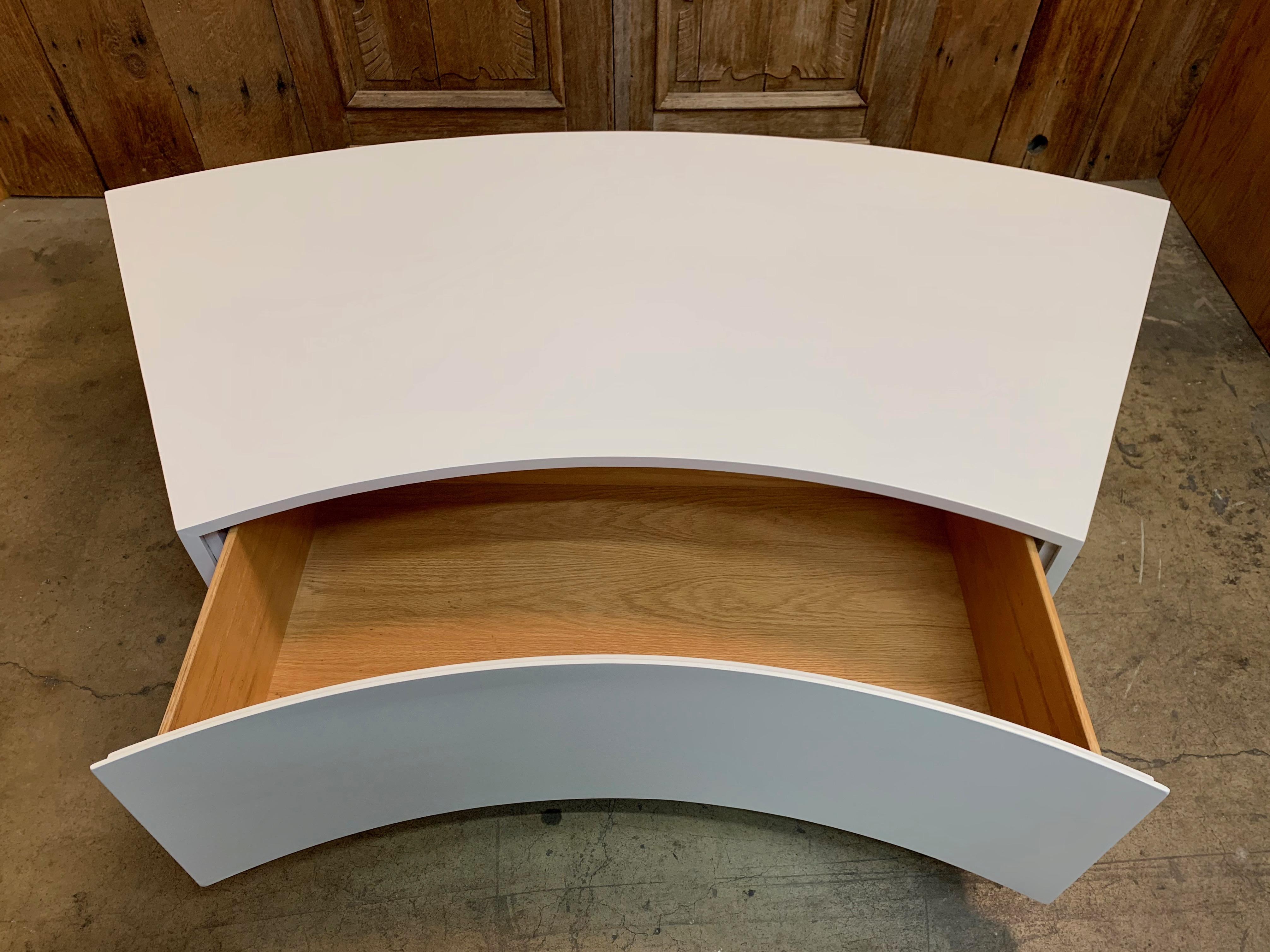 White satin lacquer over wood atop Lucite support bars with curved front drawer 
Perfect for curved sofa. Can also be used as a coffee table
