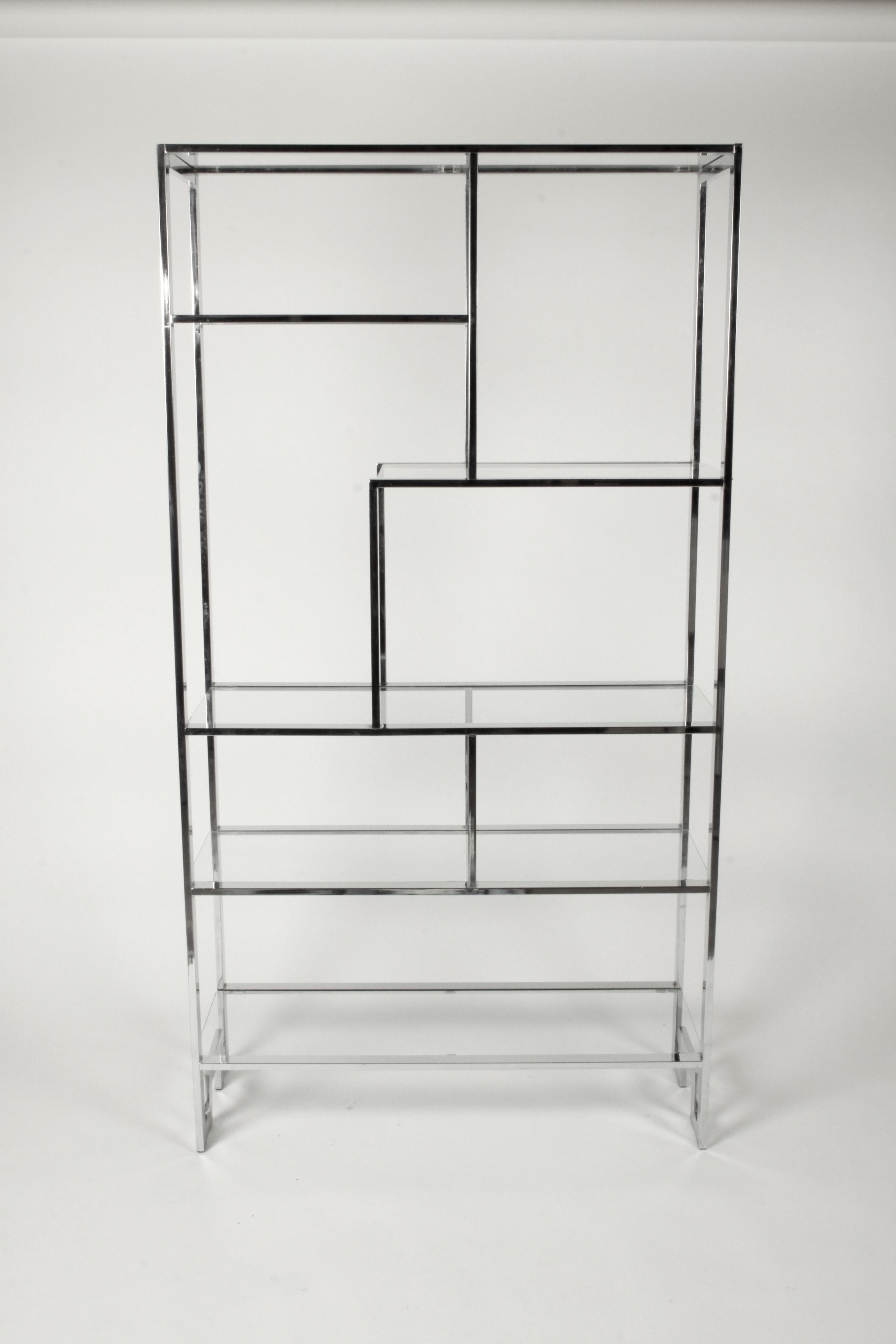 Chrome geometric configuration étagère by Milo Baughman for DIA or Design Institute of America with glass shelves and Greek key detail in base. Very nice original condition, chrome is bright, few minor chips to edges of glass and light scratches.