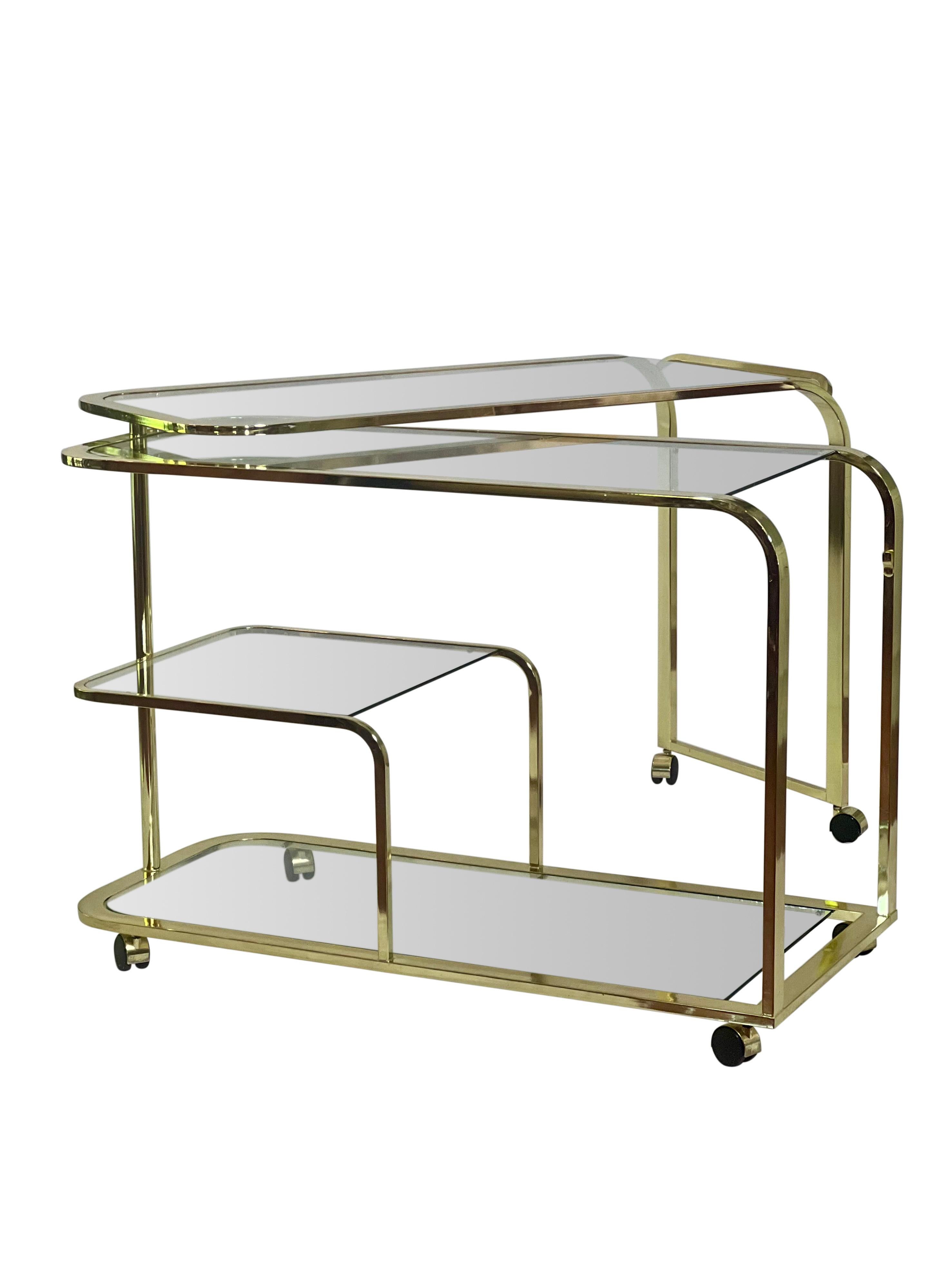 Iconic Milo Baughman expandable rolling bar cart by DIA.

This coveted piece features multiple glass tiers and a unique unfolding design. The top swivels a continuous 360 degrees allowing for countless configurations to suit your needs. It is in