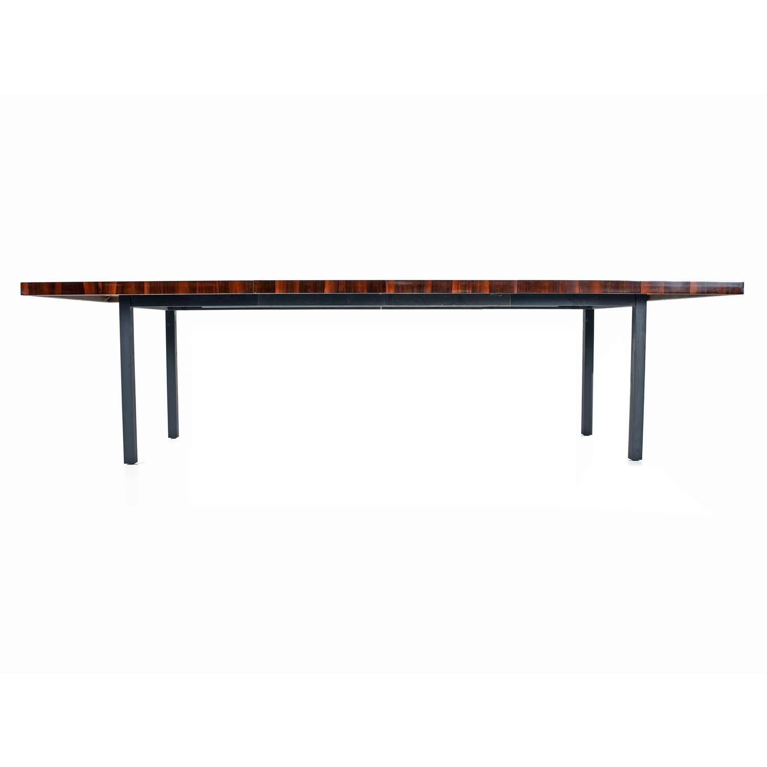 Fabulous Mid-Century Modern dining table by Milo Baughman for Dillingham. The striated designed is created by layers of rosewood, walnut and hickory veneers. The striking array of wood tones is contrasted by flat black ebony stained legs. Table