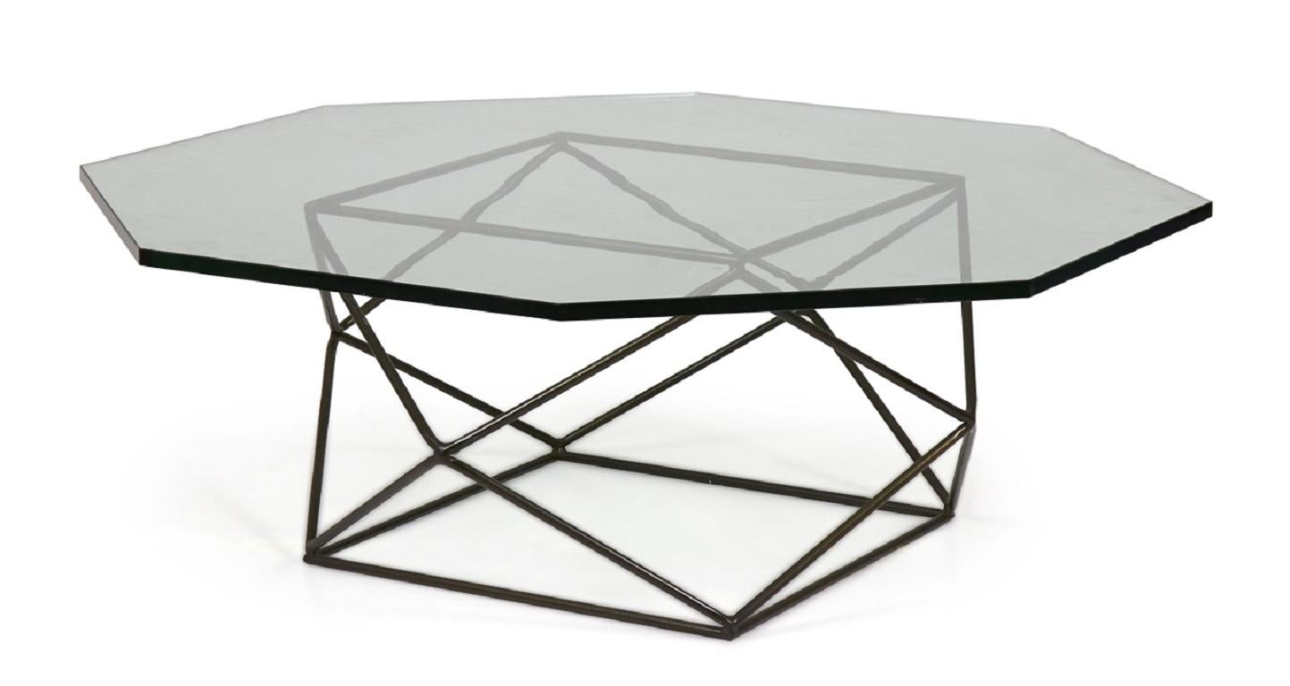 American Mid-Century (1972) geometric bronze frame coffee table with a faceted octagonal glass top. (MILO BAUGHMAN FOR DIRECTIONAL)