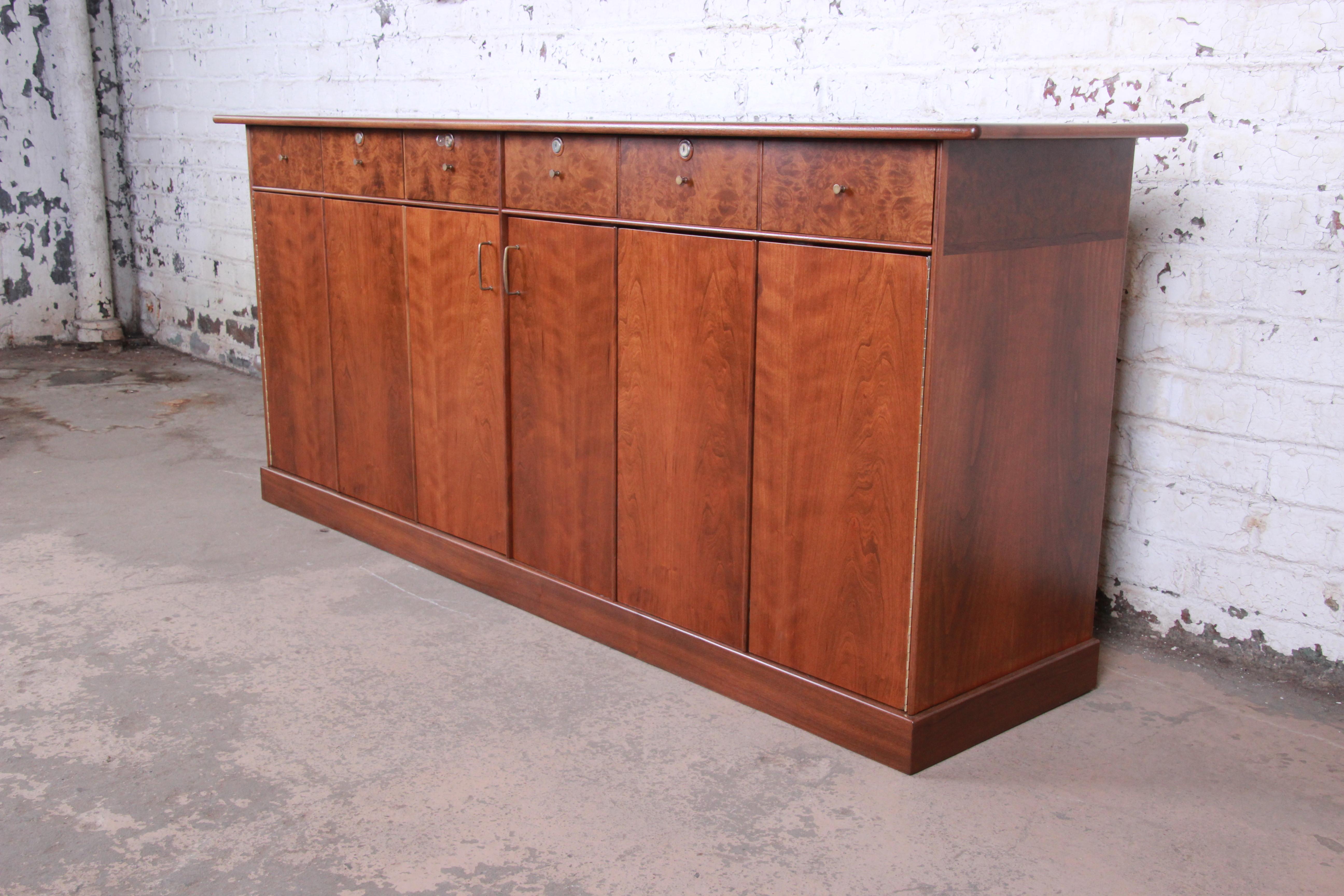 A rare and outstanding Mid-Century Modern dresser or credenza designed by Milo Baughman for his Country Villa collection for Directional. The dresser features stunning wood grain in cherrywood and walnut and myrtle burl woods. It offers exceptional