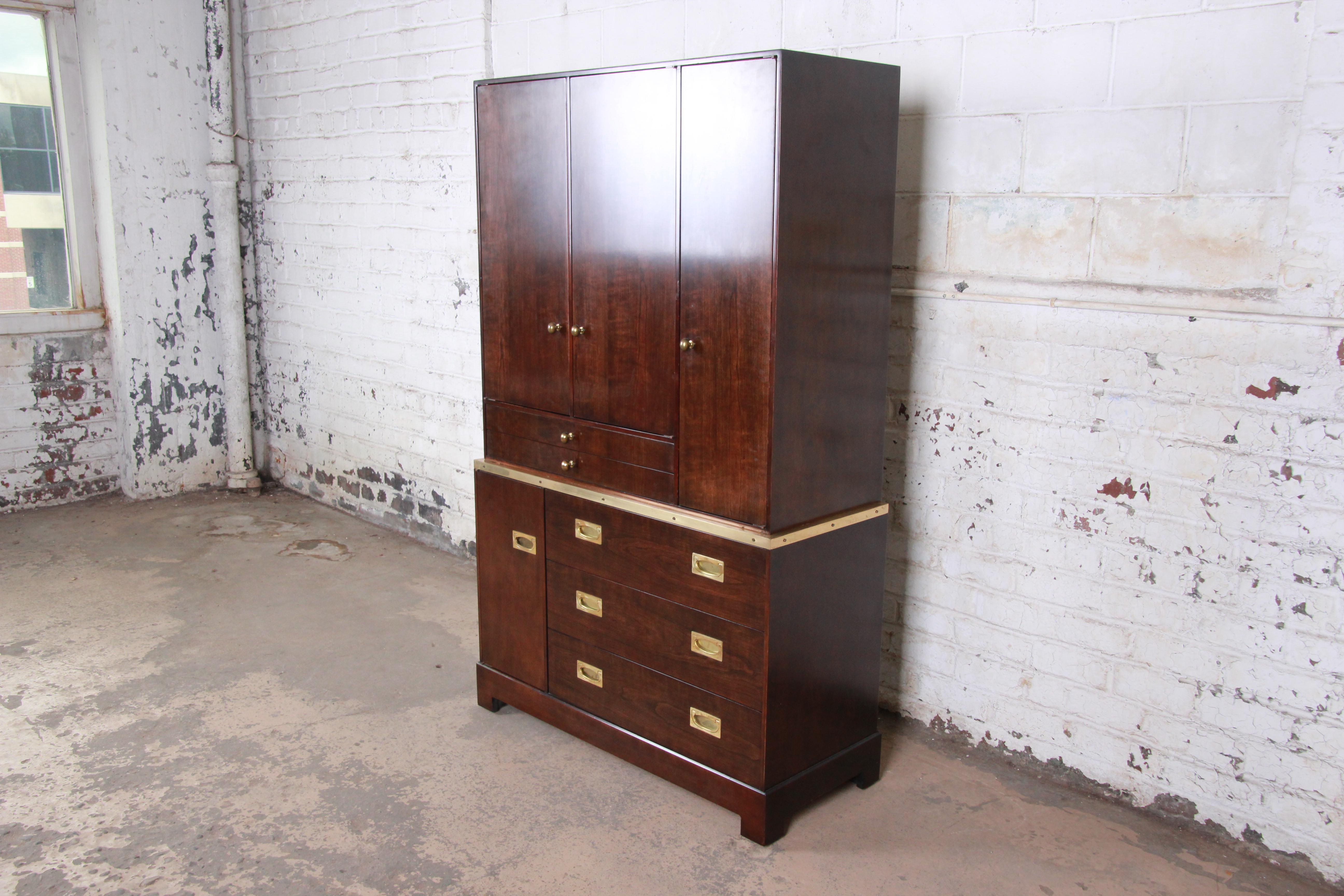 An exceptional Mid-Century Modern Hollywood Regency Campaign style gentleman's chest by Milo Baughman for the exclusive Custom collection for Directional. The chest features rich wood grain with elegant brass trim and original brass hardware. It