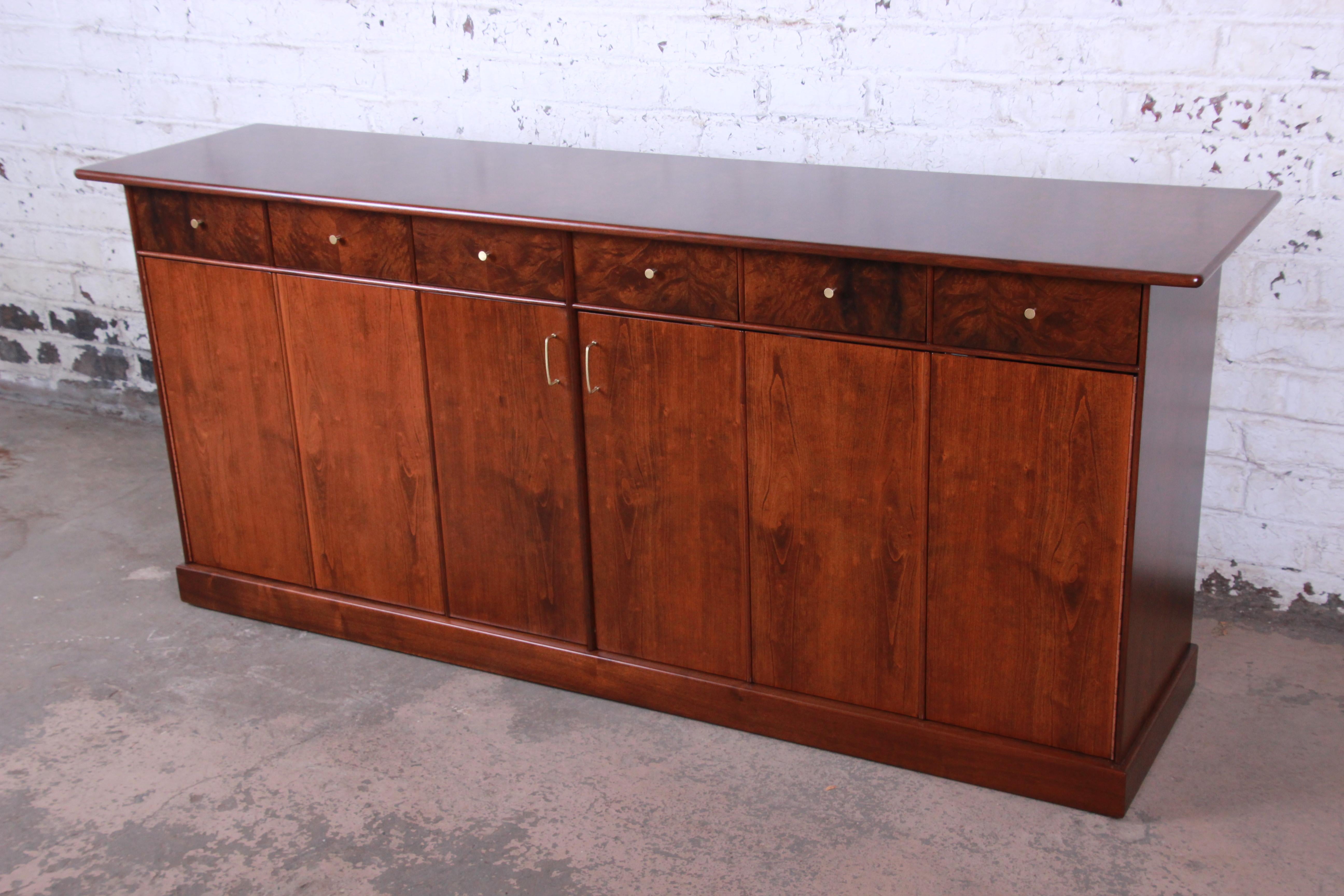 A rare and outstanding Mid-Century Modern dresser or credenza designed by Milo Baughman for his Country Villa collection for Directional. The dresser features stunning and rich wood grain in cherrywood and walnut and myrtle burl woods. It offers