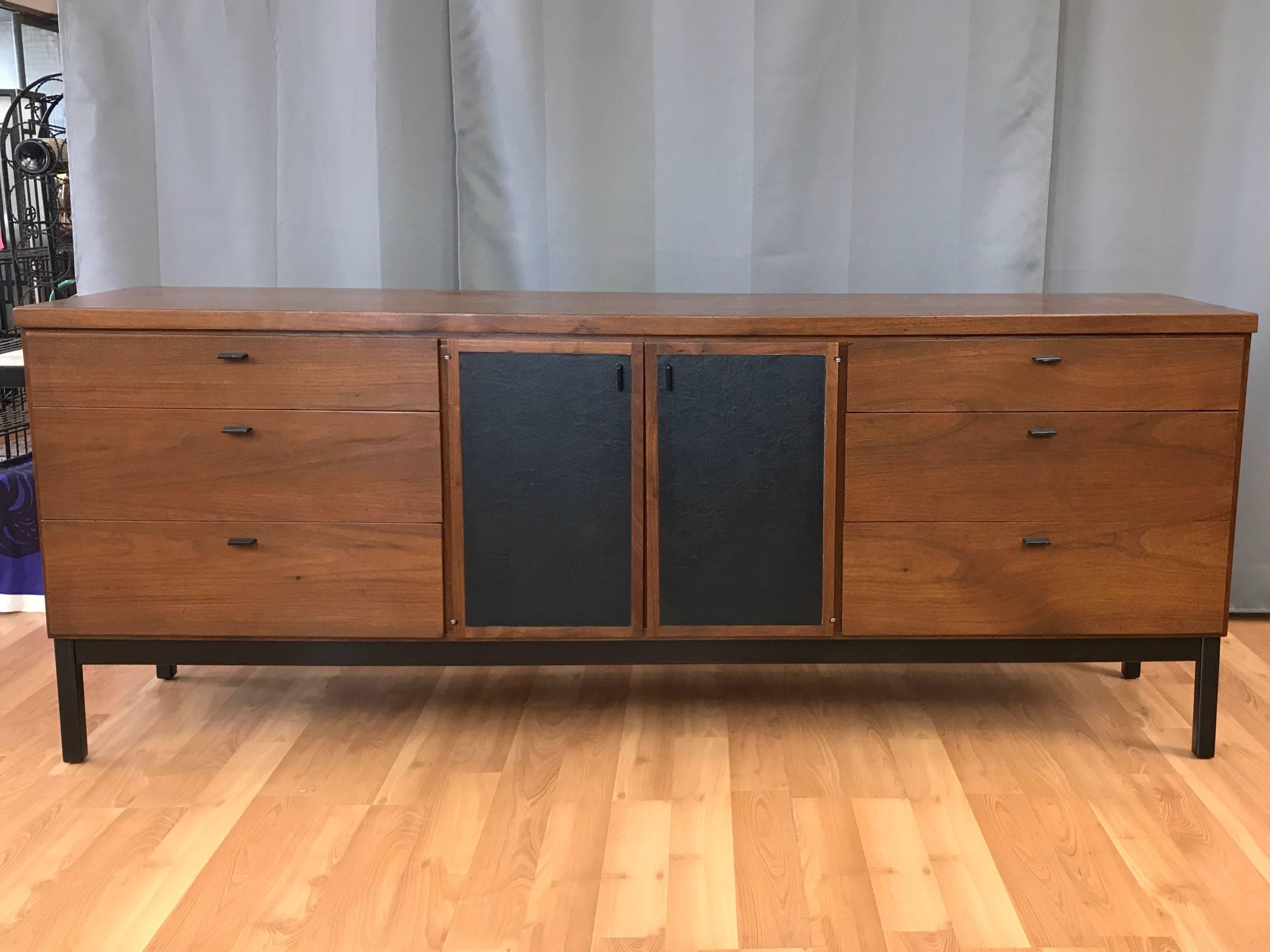 An expansive nine-drawer walnut dresser by Milo Baughman for Directional.

A very fine example of handsomely understated American mid-century modern design. Three drawers on either end with nicely highlighted dovetail joinery. A pair of doors