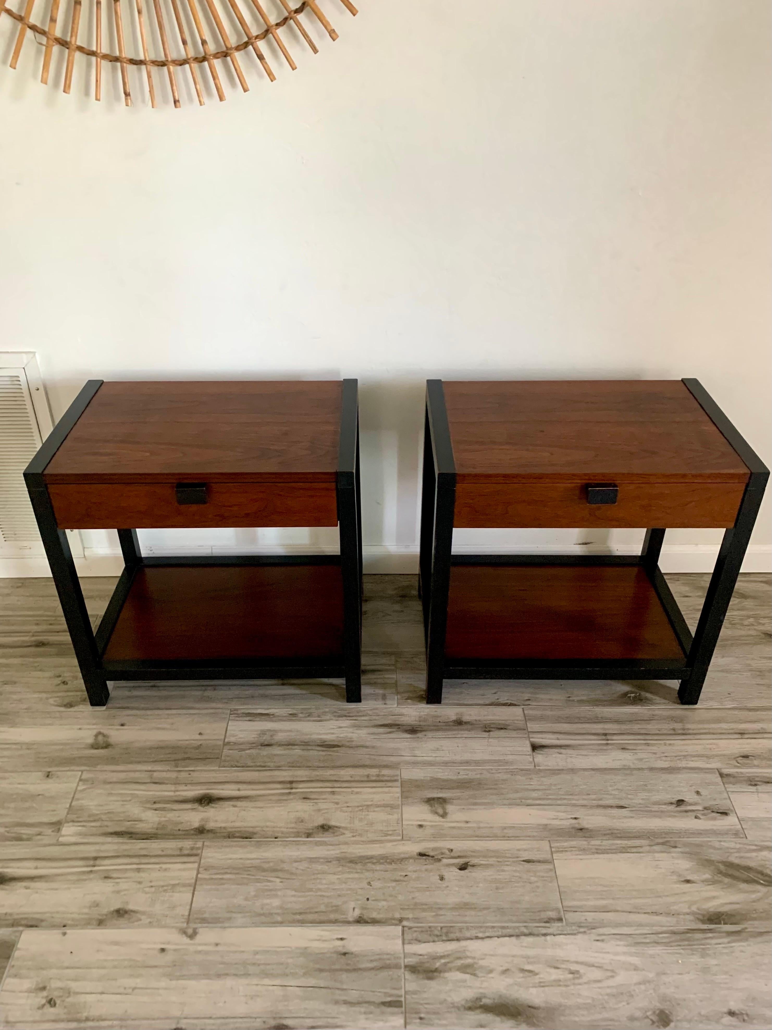 Exception pair of Mid Century Modern nightstands 

Designed by Milo Baughman for Directional. 

USA, 1960s. 

Walnut cases with ebonized frames and hardware. 

22.5” tall, 15” deep, 22” wide. 

Tops and drawers have been refinished and color match.