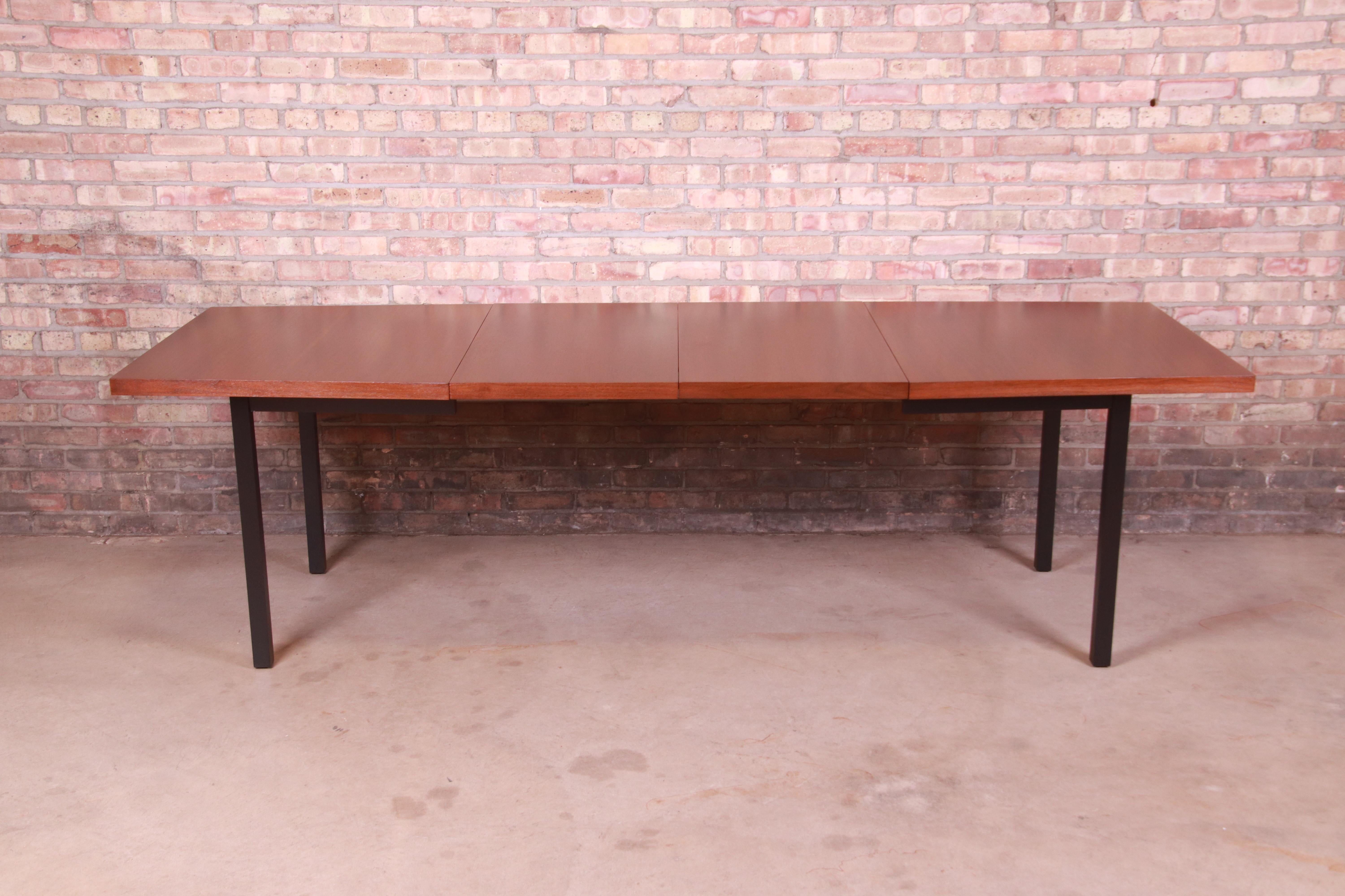An exceptional mid-century modern boat-shaped extension dining table

By Milo Baughman for Directional

USA, 1960s

Gorgeous book-matched walnut, with ebonized legs.

Measures: 60