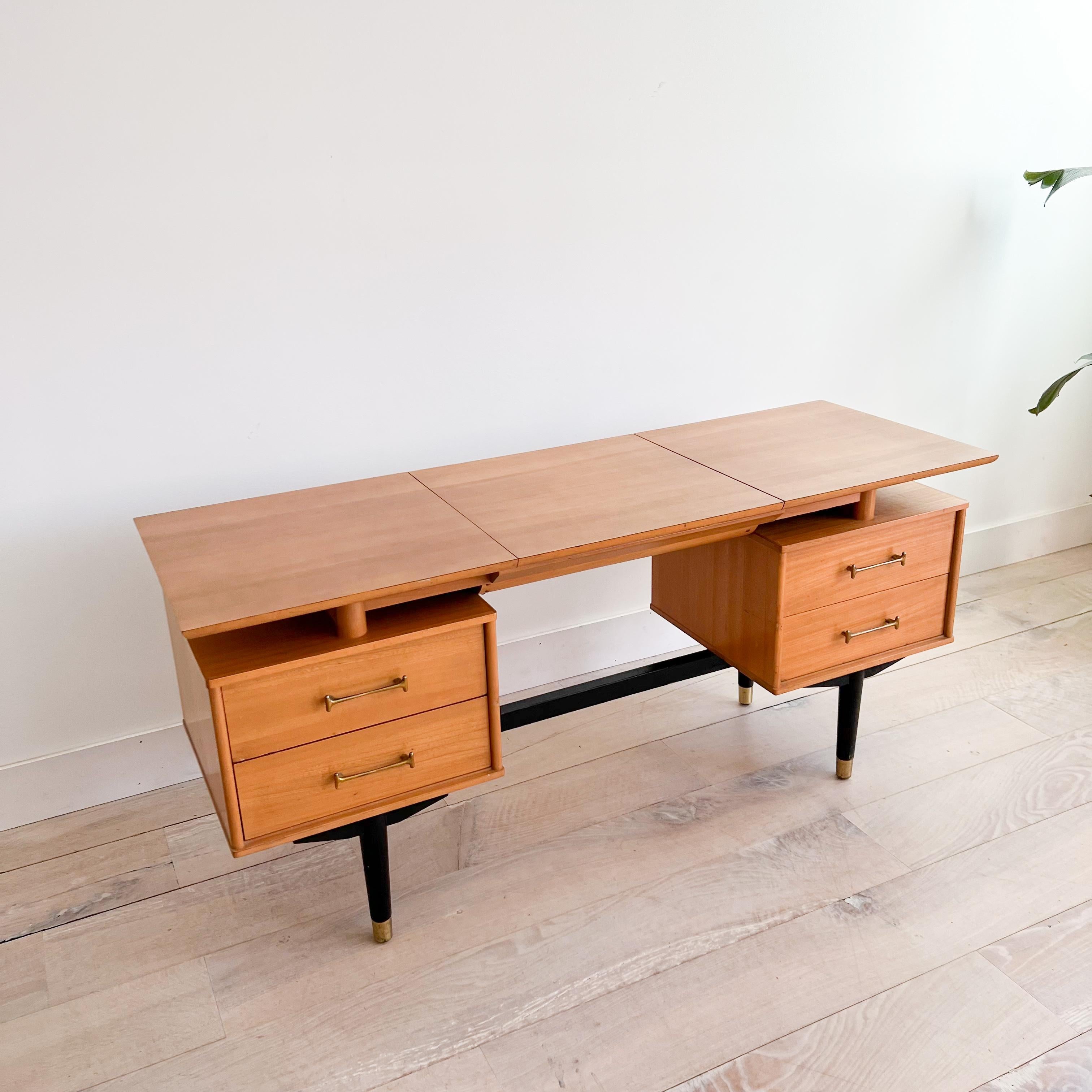 Mid century modern desk/vanity by Milo Baughman for the Today’s Living line by Drexel. Solid elm construction with brass “dog bone” hardware. Some light scuffing/scratching from age appropriate wear.

60”x20.5” 27.25”H

Knee clearance - 23.25” wide