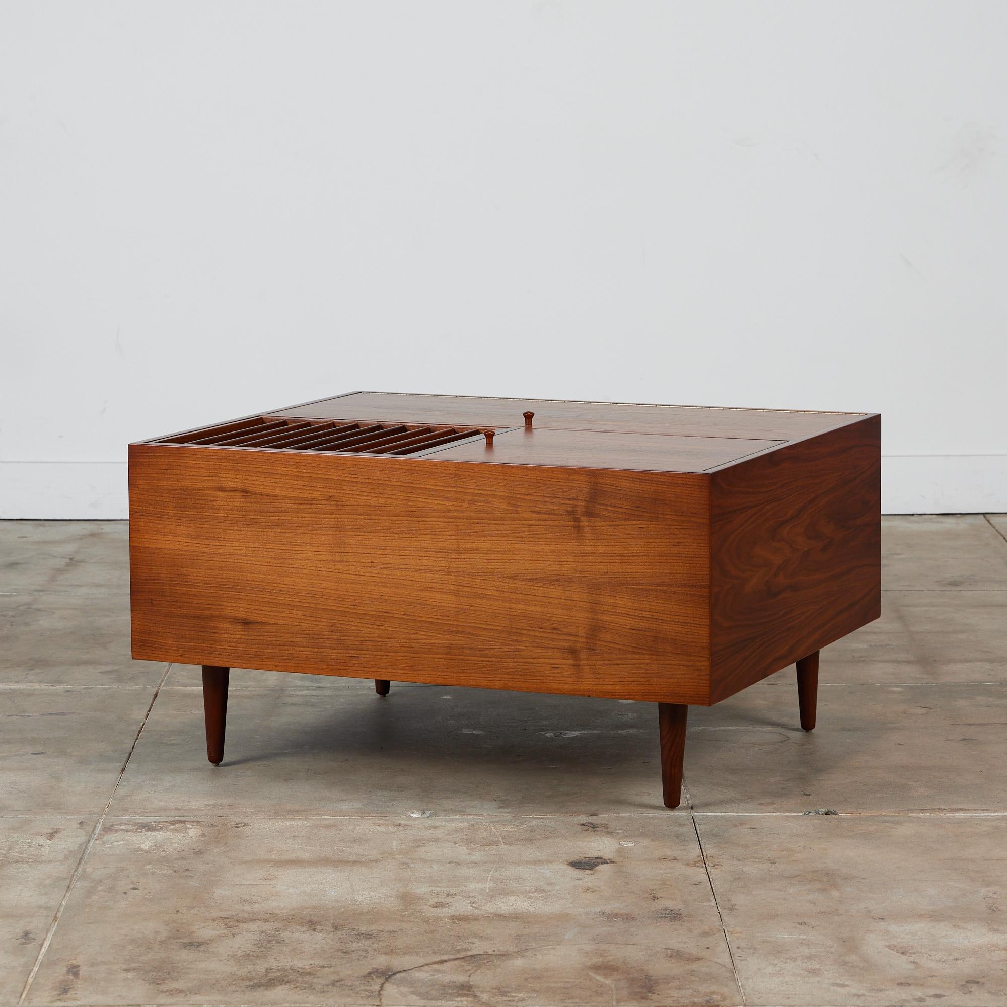 Large walnut coffee table by Milo Baughman for Glenn of California c.1950s, USA. This unique table features ample storage with two deep hinged cabinet doors. The cabinets open to reveal one large storage cabinet and a divided storage cabinet. A