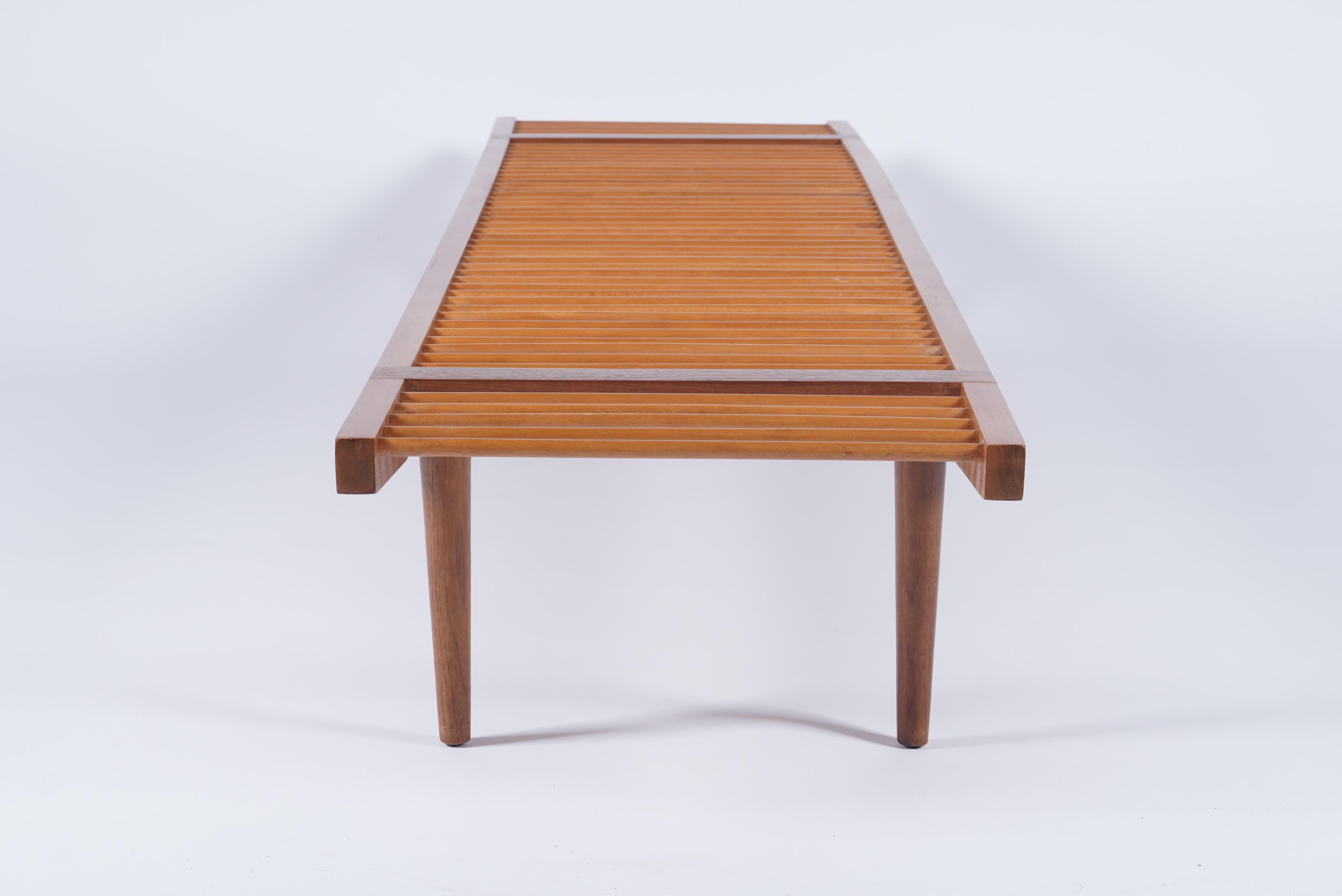 Long dowel bench in walnut and maple by Milo Baughman for Glenn of California, late 1950s. Professionally restored as original. Excellent for plants, it is a quintessentially modernist design. Beautiful and ready for use. 

81” long 18” deep 11.5”