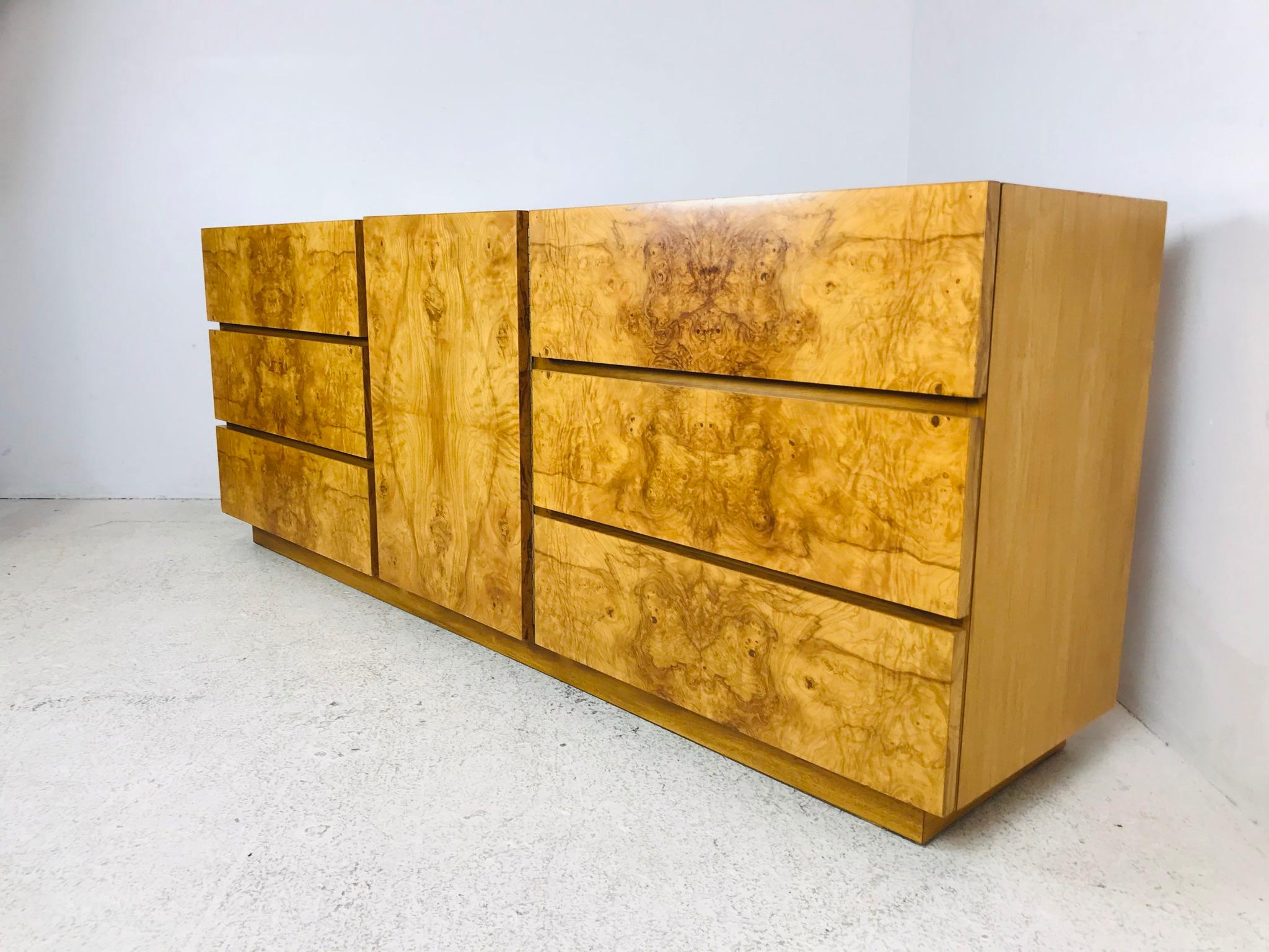 Beautiful 1970s burl-wood dresser. Three drawers behind middle door flanked on each side by three large drawers. Originally designed by Roland Carter for Lane Furniture, this 