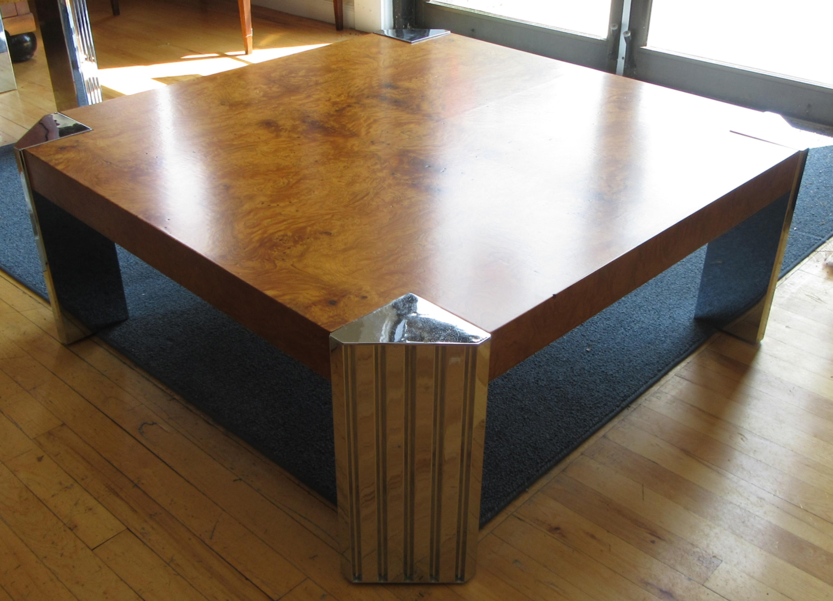 A bookmatched olive burl wood coffee table with chromed 