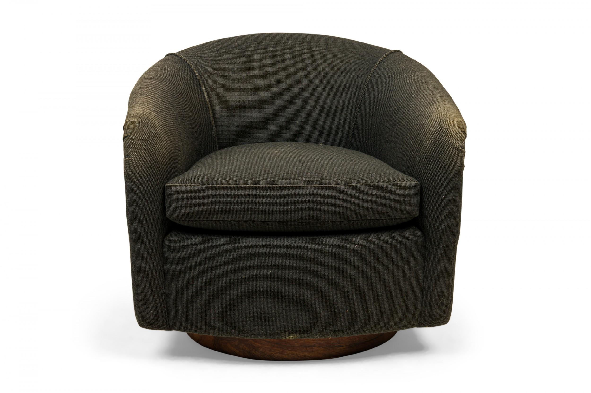 American Mid-Century horseshoe-form lounge / armchair with black textured fabric upholstery with removable seat cushion and a rosewood wrap around the back of the chair. (MILO BAUGHMAN FOR THAYER COGGIN)