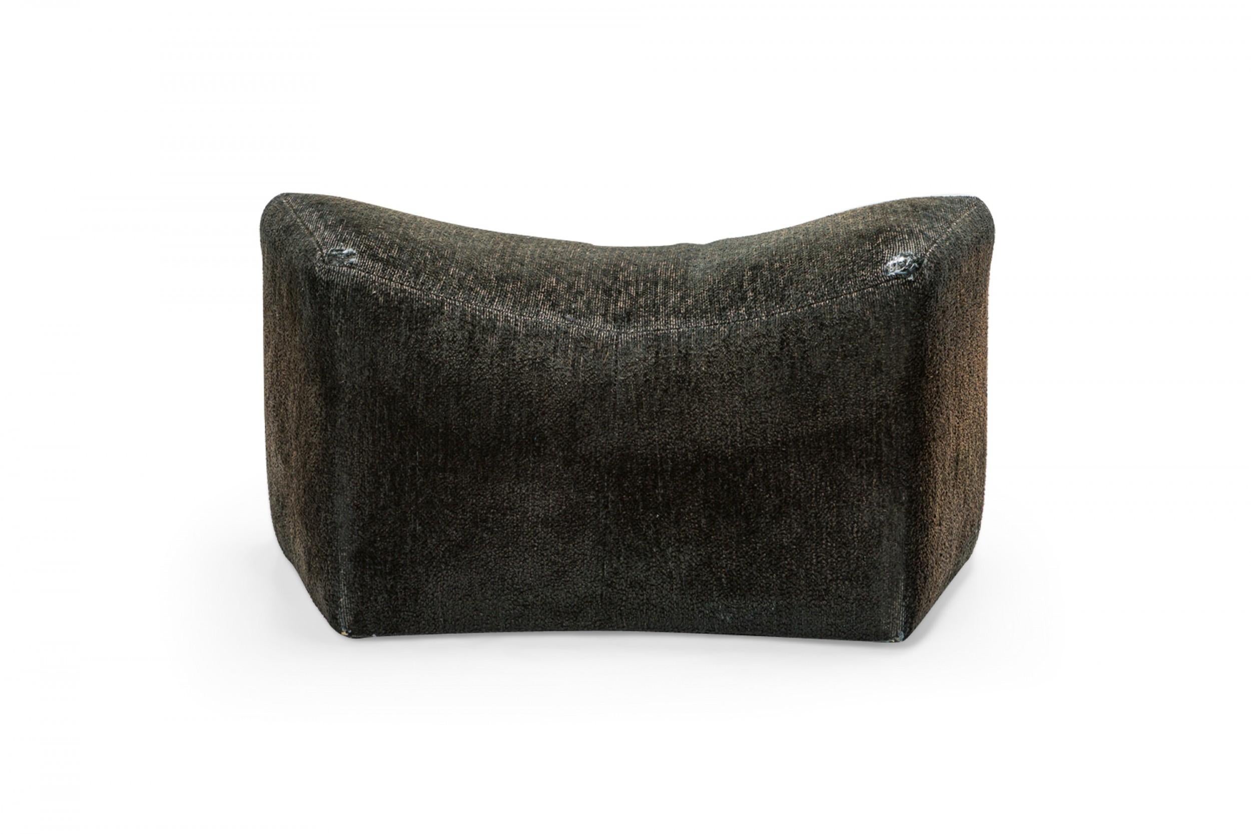 American Mid-Century saddle ottoman with textured black upholstery. (MILO BAUGHMAN)(Pair available in yellow: DUF0344)