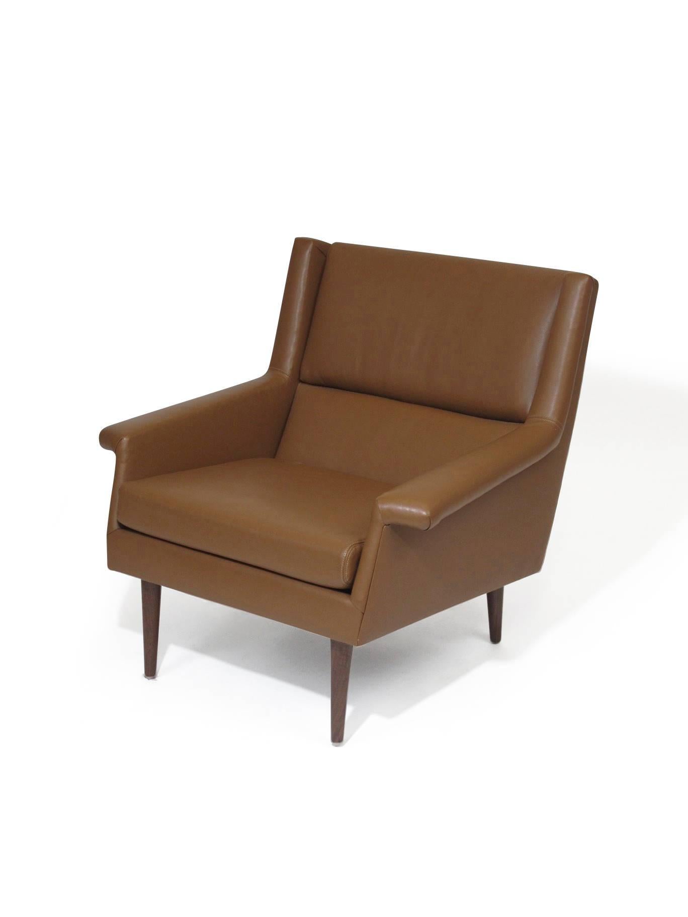 Lounge chair designed by Milo Baughman for Thayer Coggin upholstered in brown leather raised on solid walnut legs.





    