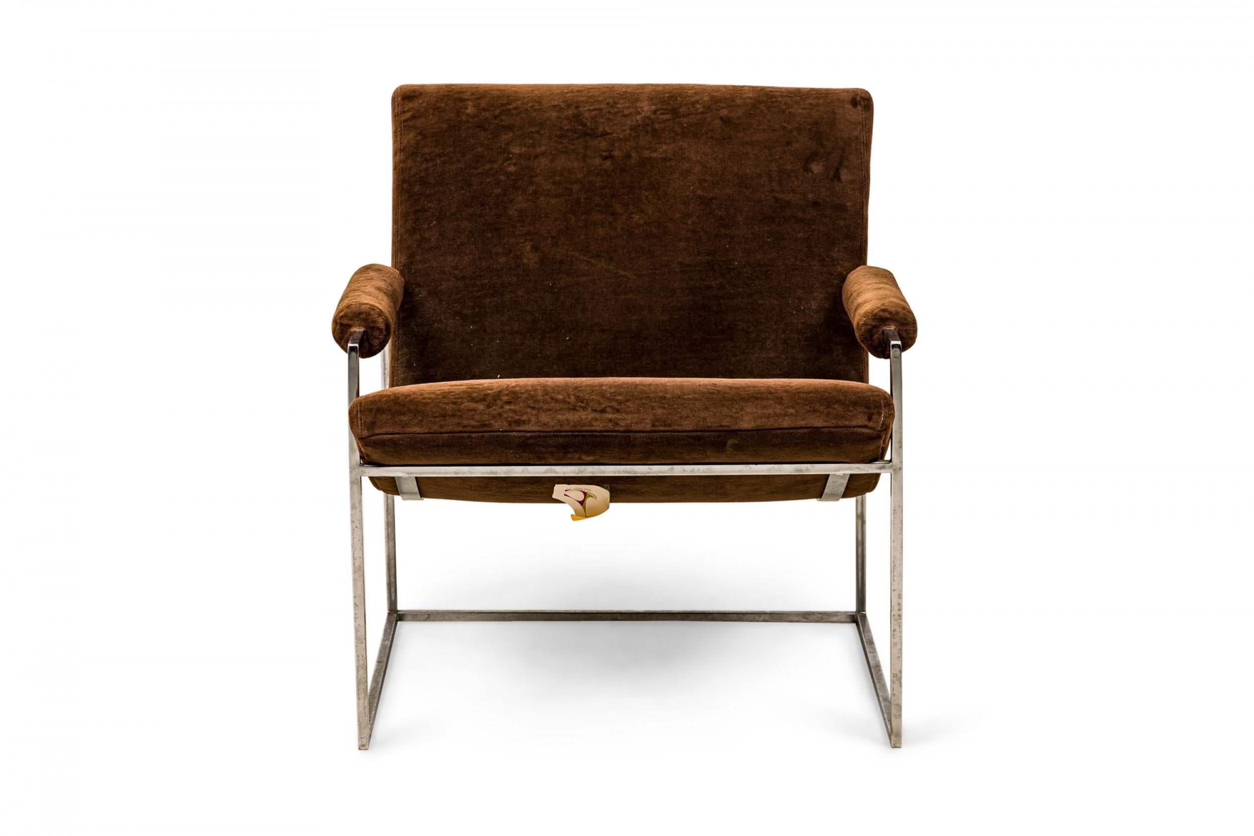American Mid-Century scoop armchair with brown velour upholstered seat, back, and arms with button tufted detail along the seam where the seat and back join, supported by a thin square tube chrome frame and legs. (MILO BAUGHMAN FOR THAYER COGGIN)