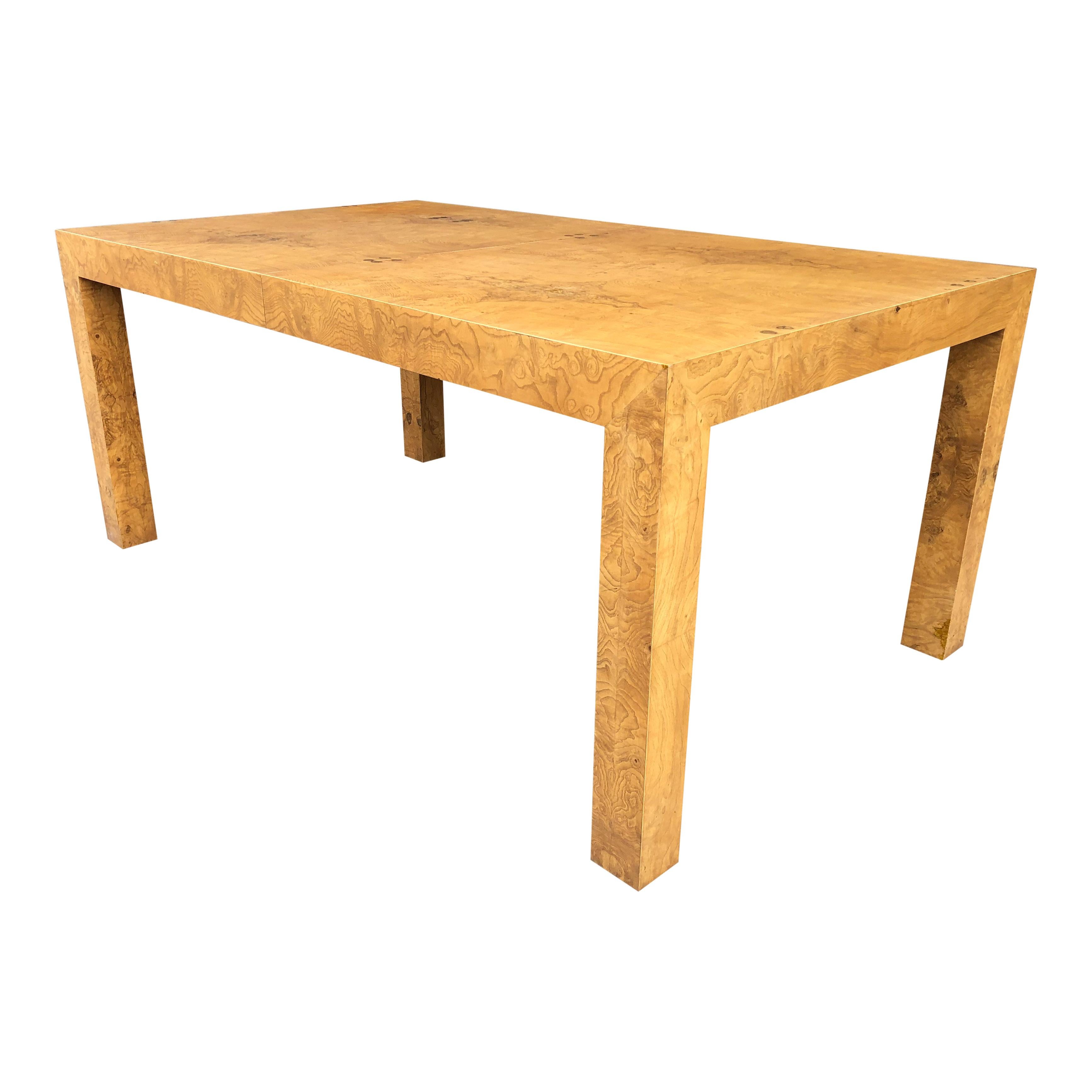 A perfectly-proportioned Parsons table by Milo Baughman, with two extension leaves. Highly figured burled olive wood. A great piece to give some pop to any room.

The table is in excellent condition, recently restored.

Dimensions: 28'' high,