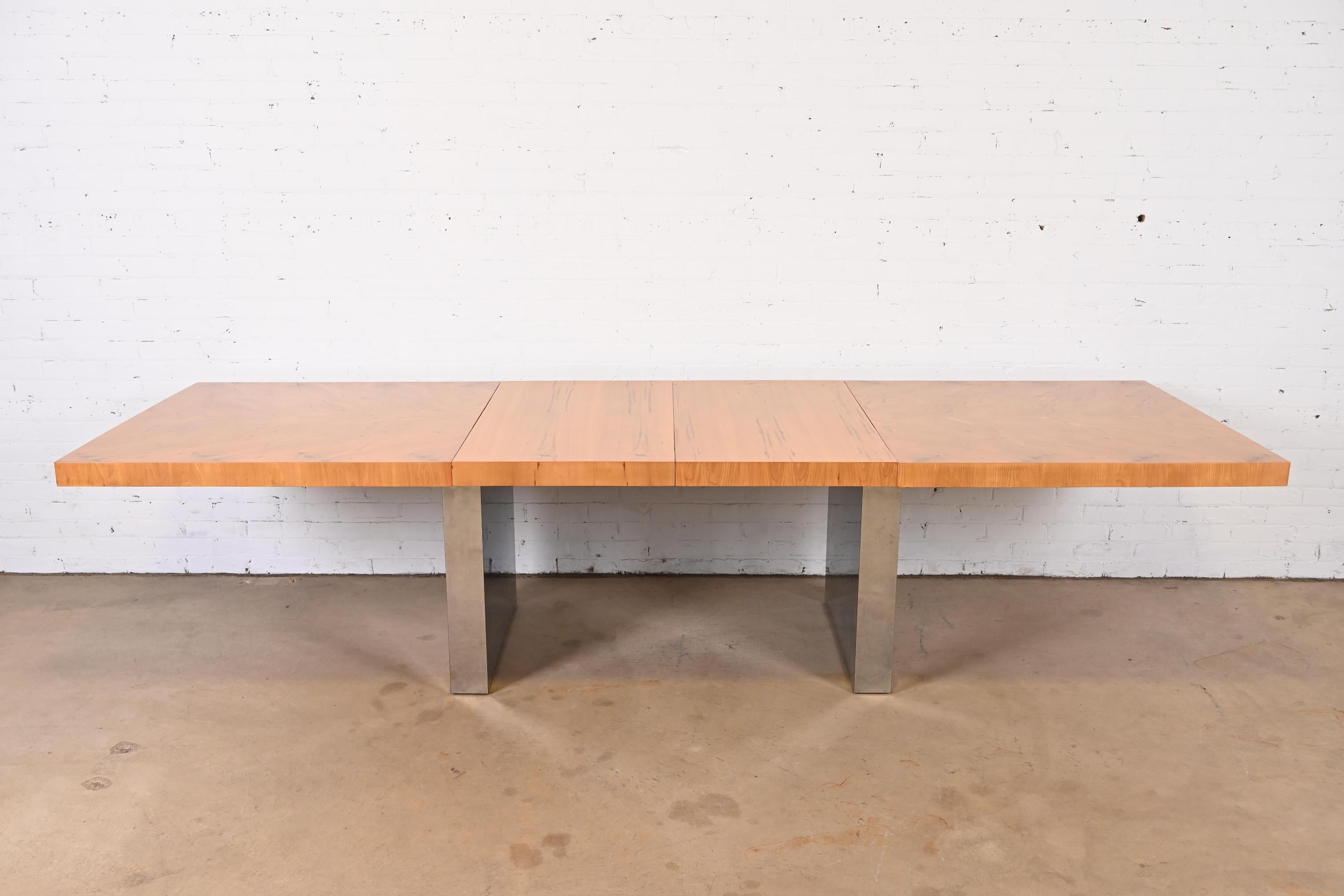 A gorgeous Mid-Century Modern extension dining table

By Milo Baughman for Thayer Coggin

USA, 1970s

Stunning book-matched burl wood, with chrome pedestal bases.

Measures: 78.25