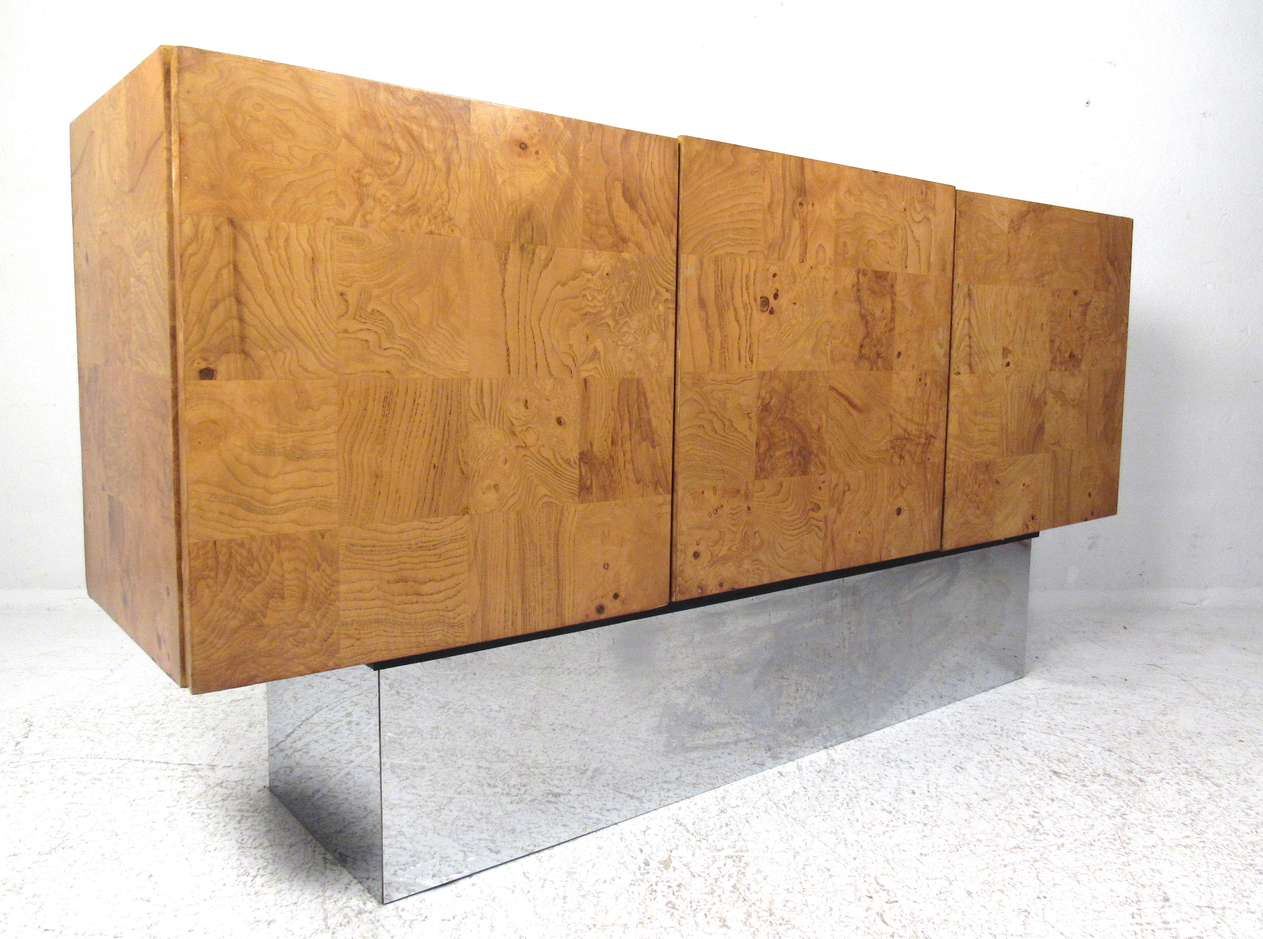 Early 1970s credenza designed by Milo Baughman for Thayer Coggin incorporates beautiful patchwork burl wood on a plinth-style tall chrome base. The interior has two storage compartments. Please confirm item location (NY or NJ) with dealer.
