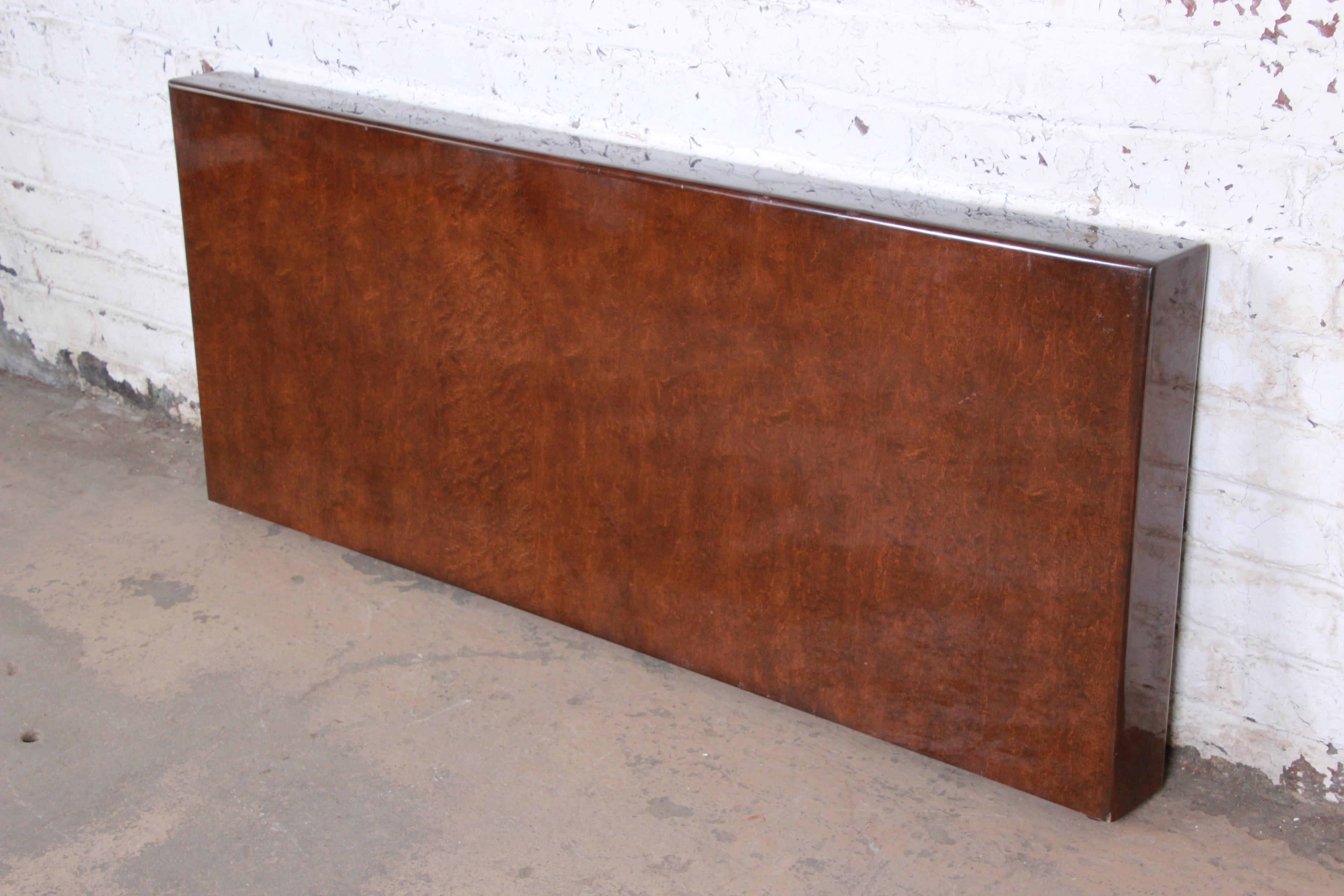 A gorgeous Mid-Century Modern queen size headboard designed by Milo Baughman for Thayer Coggin, circa 1970s. The headboard features stunning burled bird's-eye maple grain and sleek, Minimalist design. Previous owner mounted to the wall as a floating