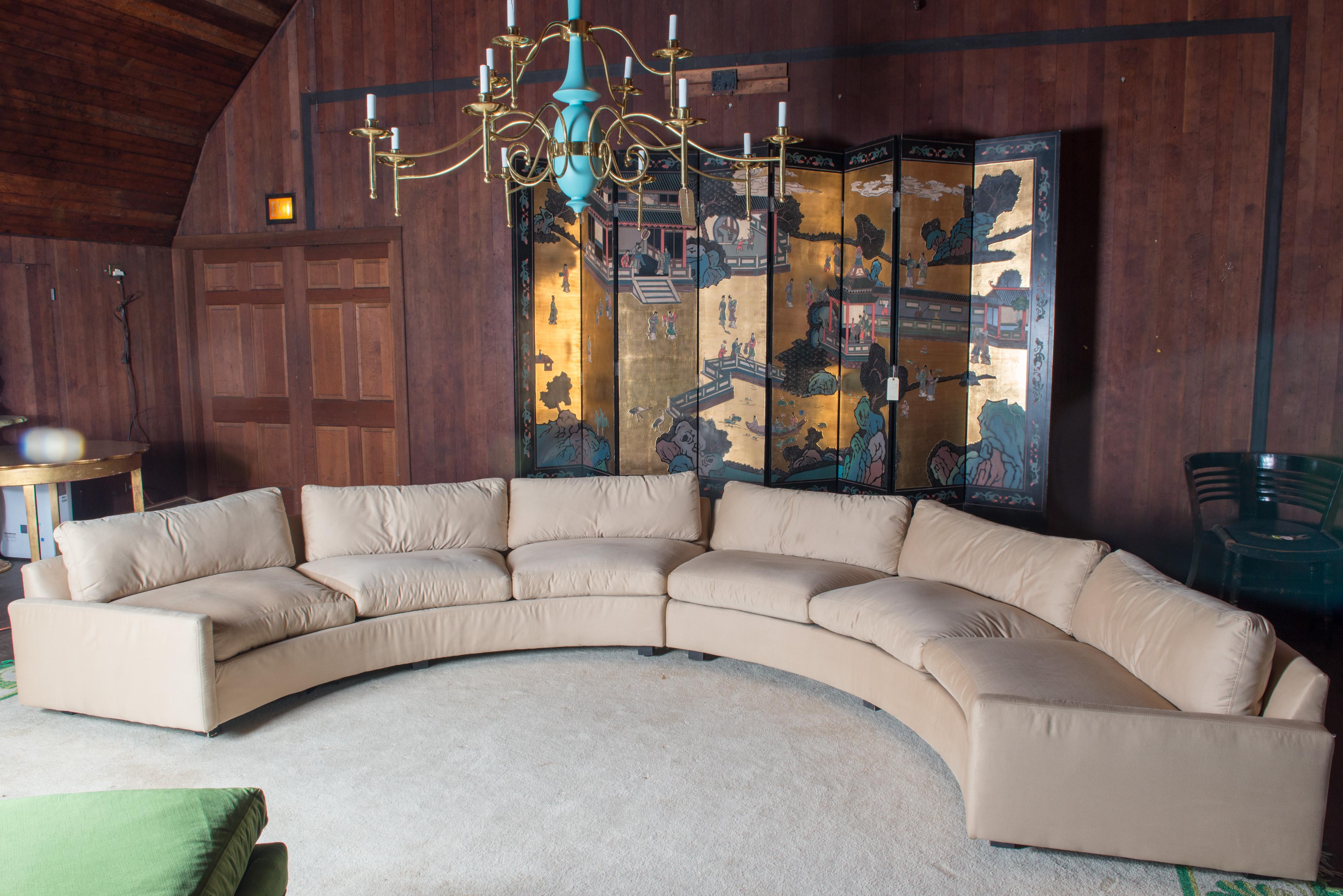 Fabulous two piece circular sectional sofa by Milo Baughman for Thayer Coggin.
The original cream colored fabric seems to be an ultra suede. There are no flaws to the fabric. It is useable. Cushions are good. The sofa has the original Thayer Coggin