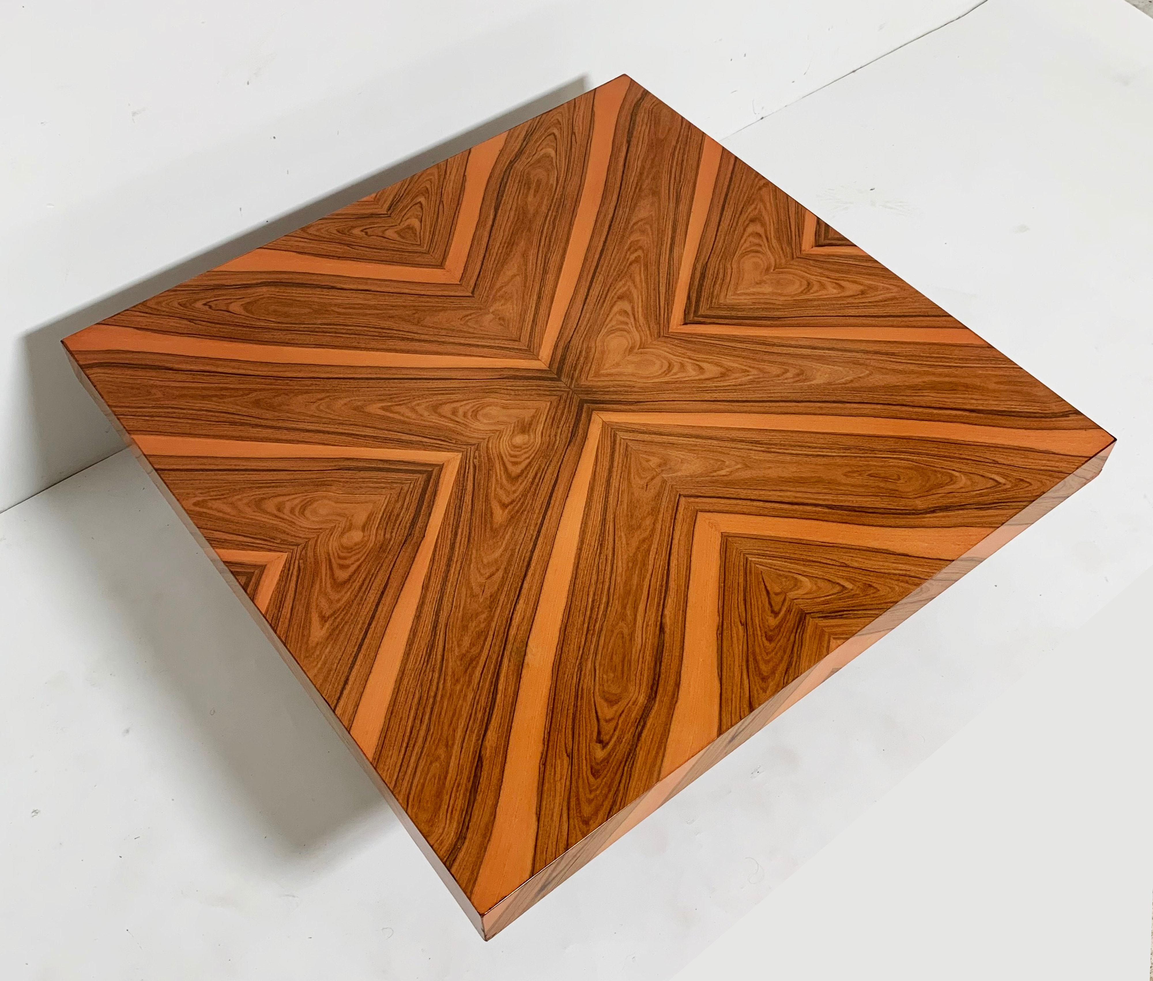 A 1970s Thayer Coggin 40” square cocktail table by Milo Baughman in reverse diamond Brasilia wood inlay pattern with chromed base.