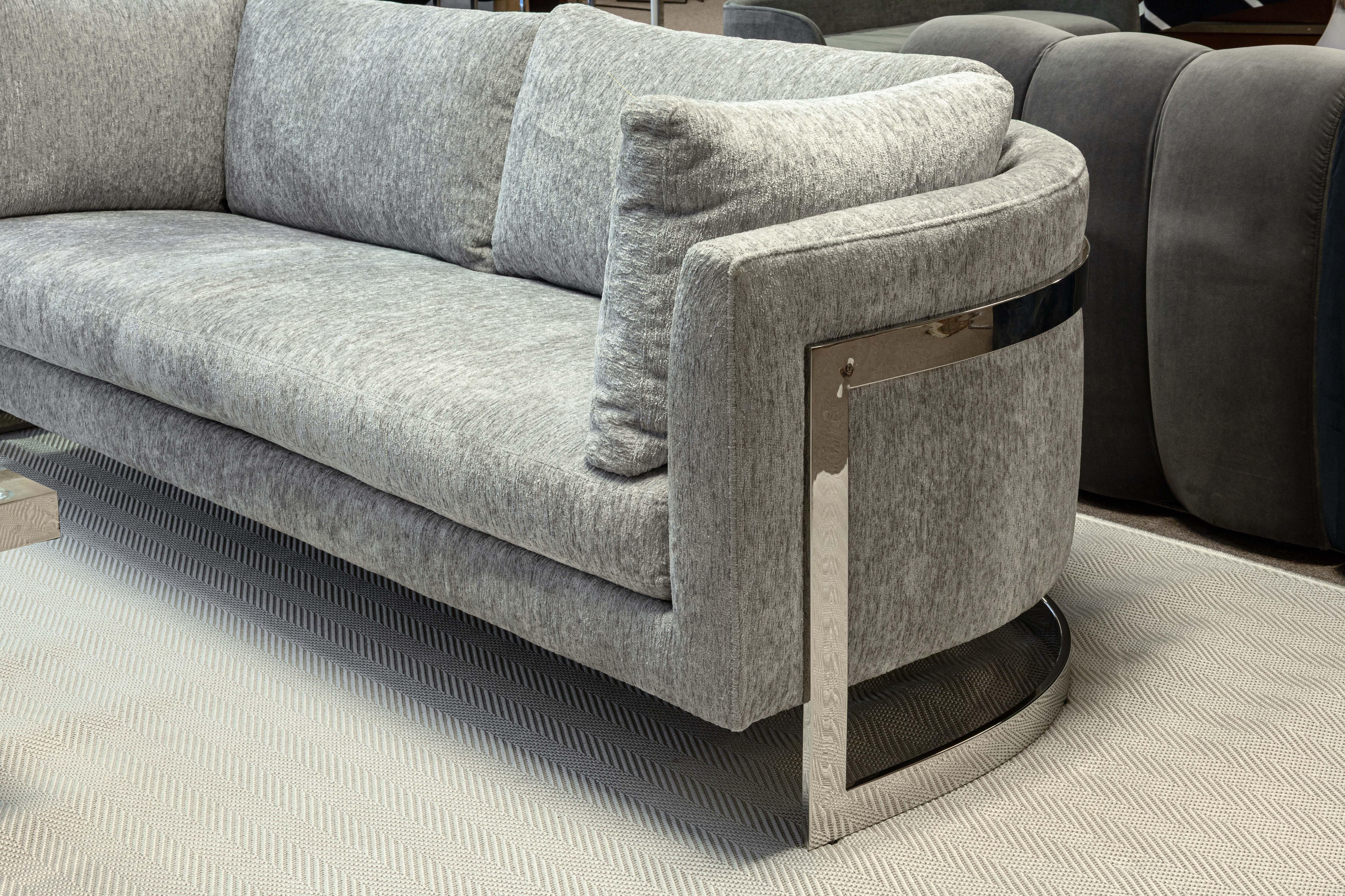 A Milo Baughman for Thayer Coggin floating chrome cantilever sofa. This is a stunning example of one of Milo Baughman's iconic floating sofas. The sofa boasts a beautiful grey chenille fabric upholstery, and a flat bar chrome frame which creates a