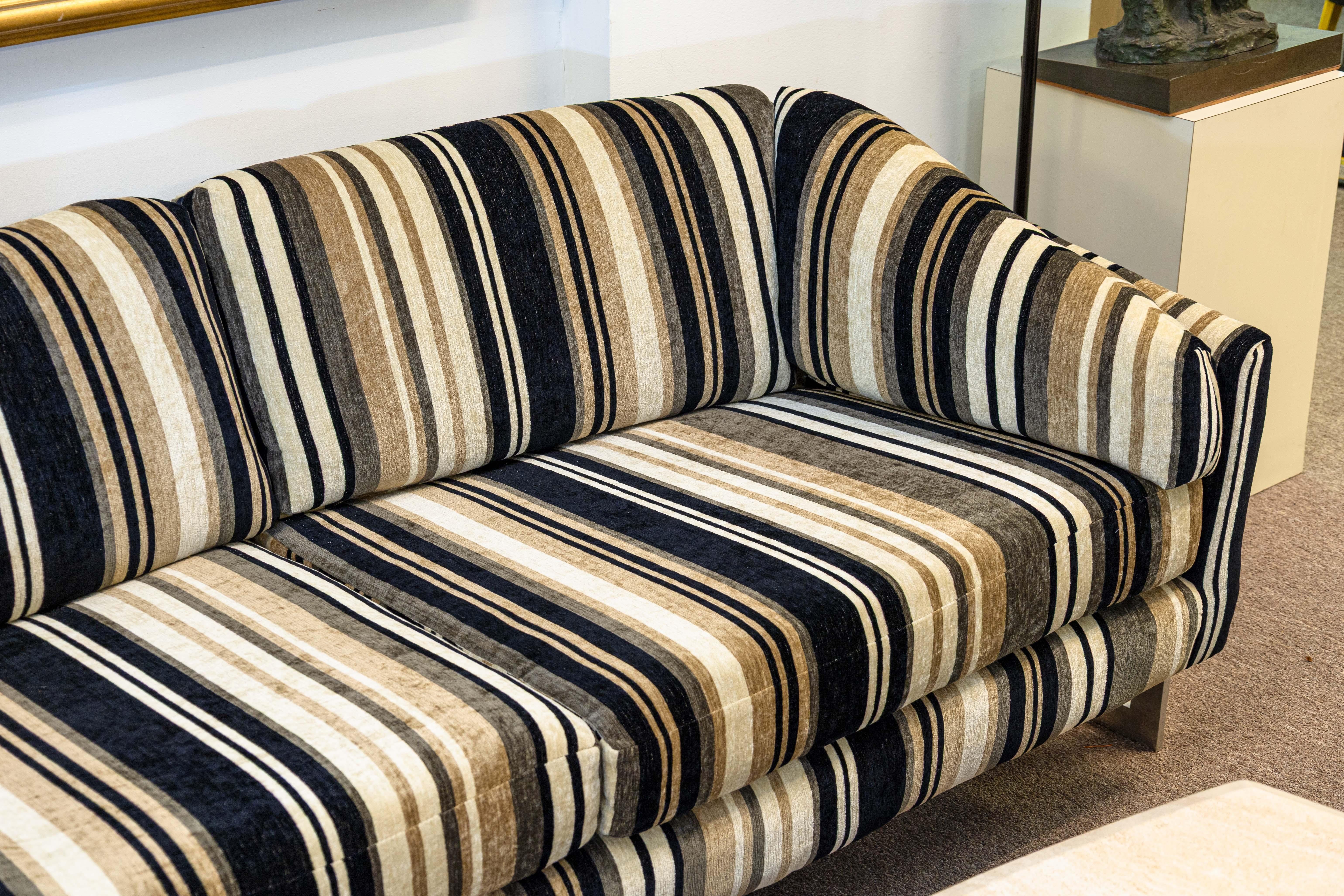 A Milo Baughman for Thayer Coggin chrome cantilever floating loveseat sofa. This is a stunning example of one of Milo Baughman's iconic floating sofas. The loveseat boasts a beautiful striped chenille fabric upholstery, and a flat bar chrome frame